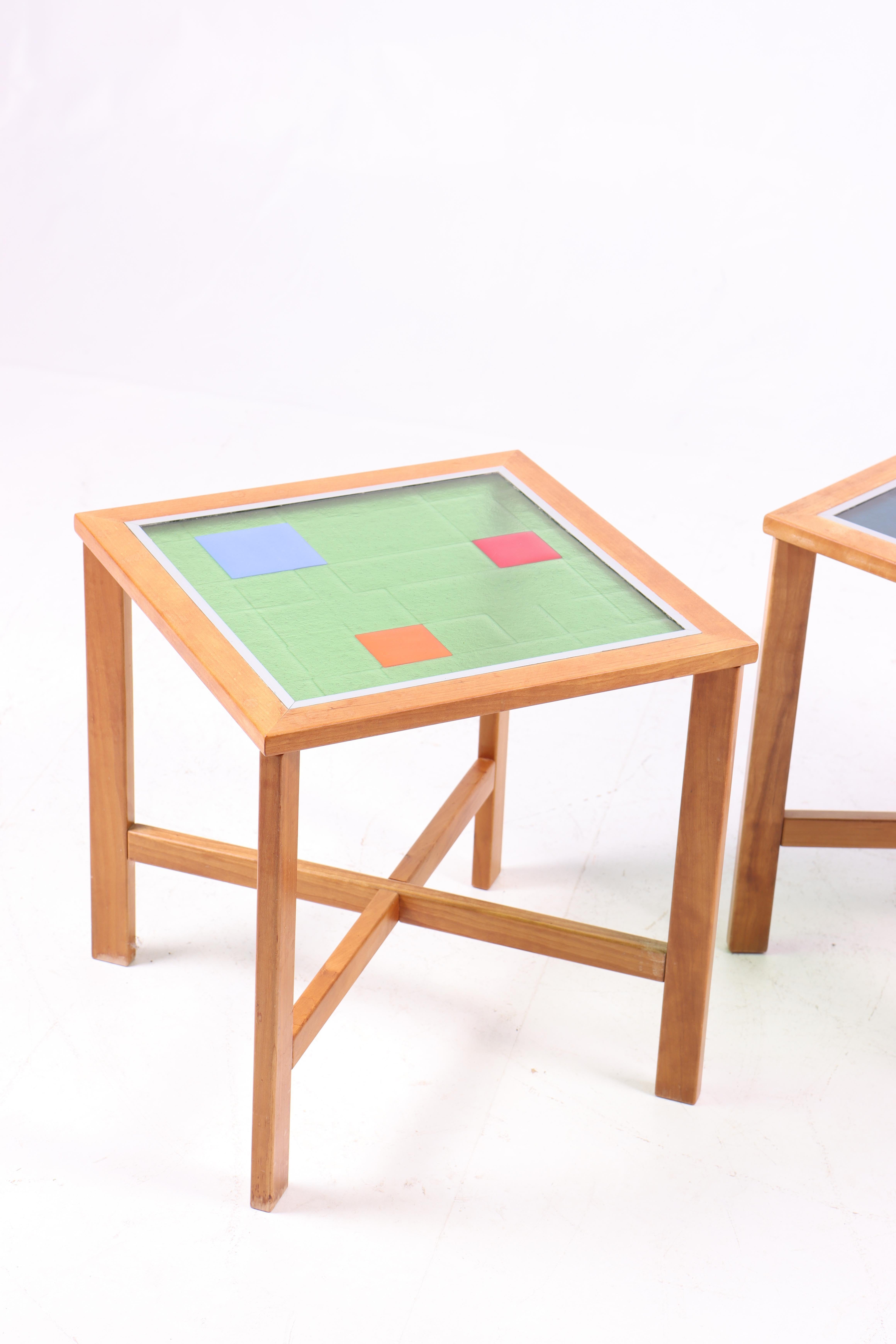 These three lamp tables were produced in the 1990s and are made of beech wood with glass tops created by a Danish glass artist. The tables feature a simple and elegant design with clean lines, characteristic of Danish furniture craftsmanship.

Each