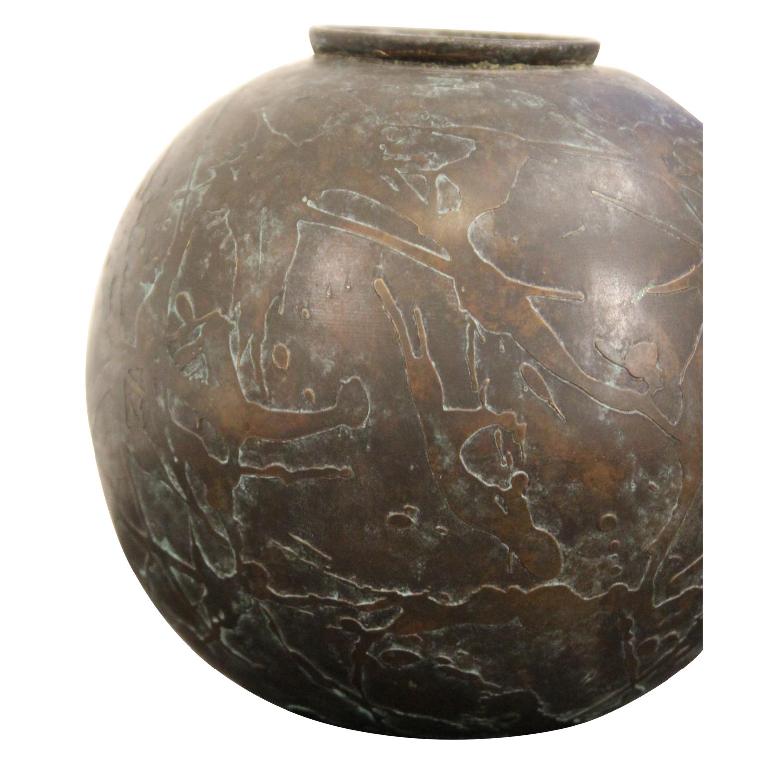 Unique abstract textured bronze vase that is perfectly circular. It has a rimmed top. It has felted bottom to protect the surface it is placed on.