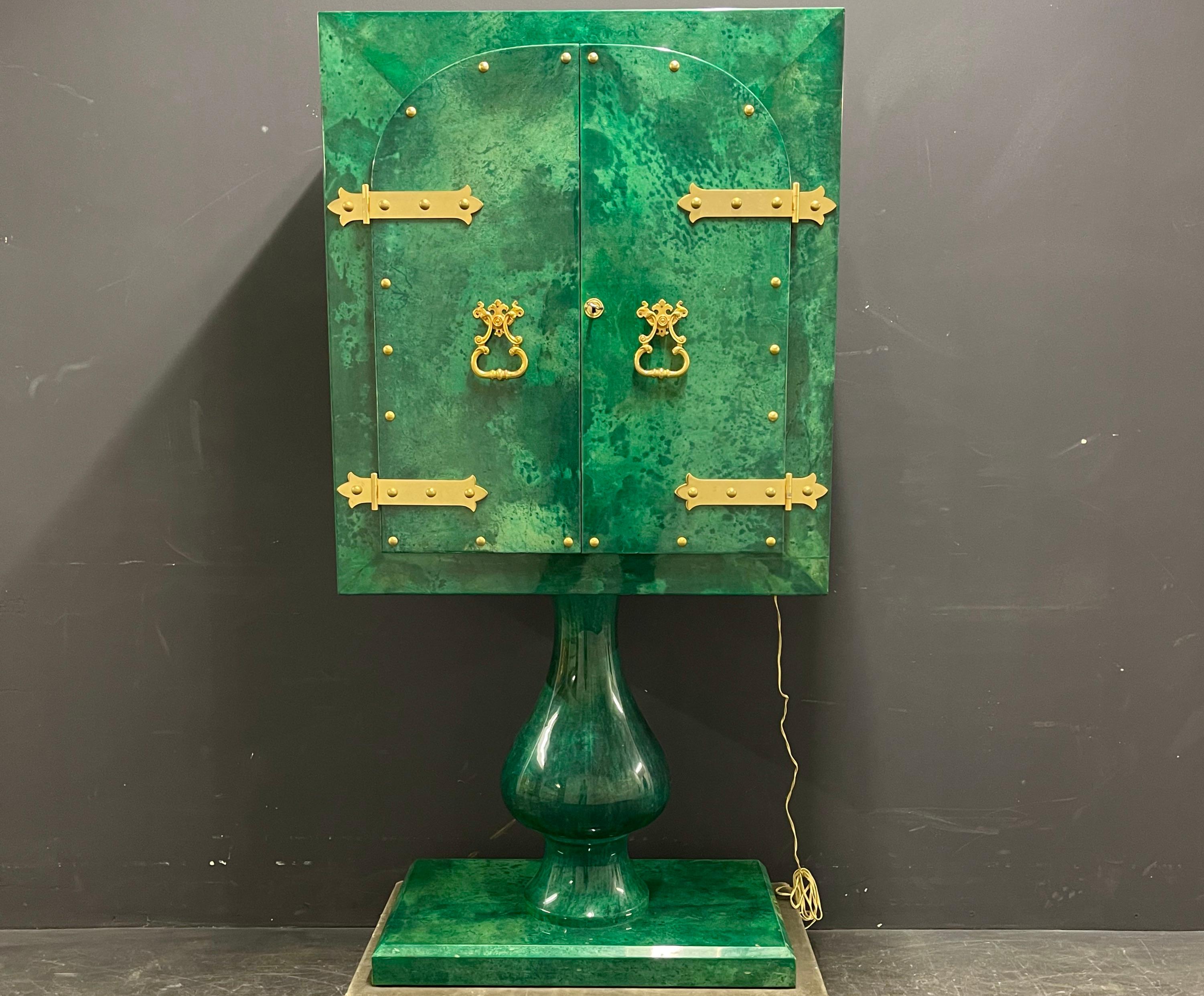 usually this typ of cabinet is made of goatskin combined with rosewood or another color. in this case aldo tura made a unique all malachite green bar cabinet on customers choice. something we never saw or heard off before. this cabinet offers the