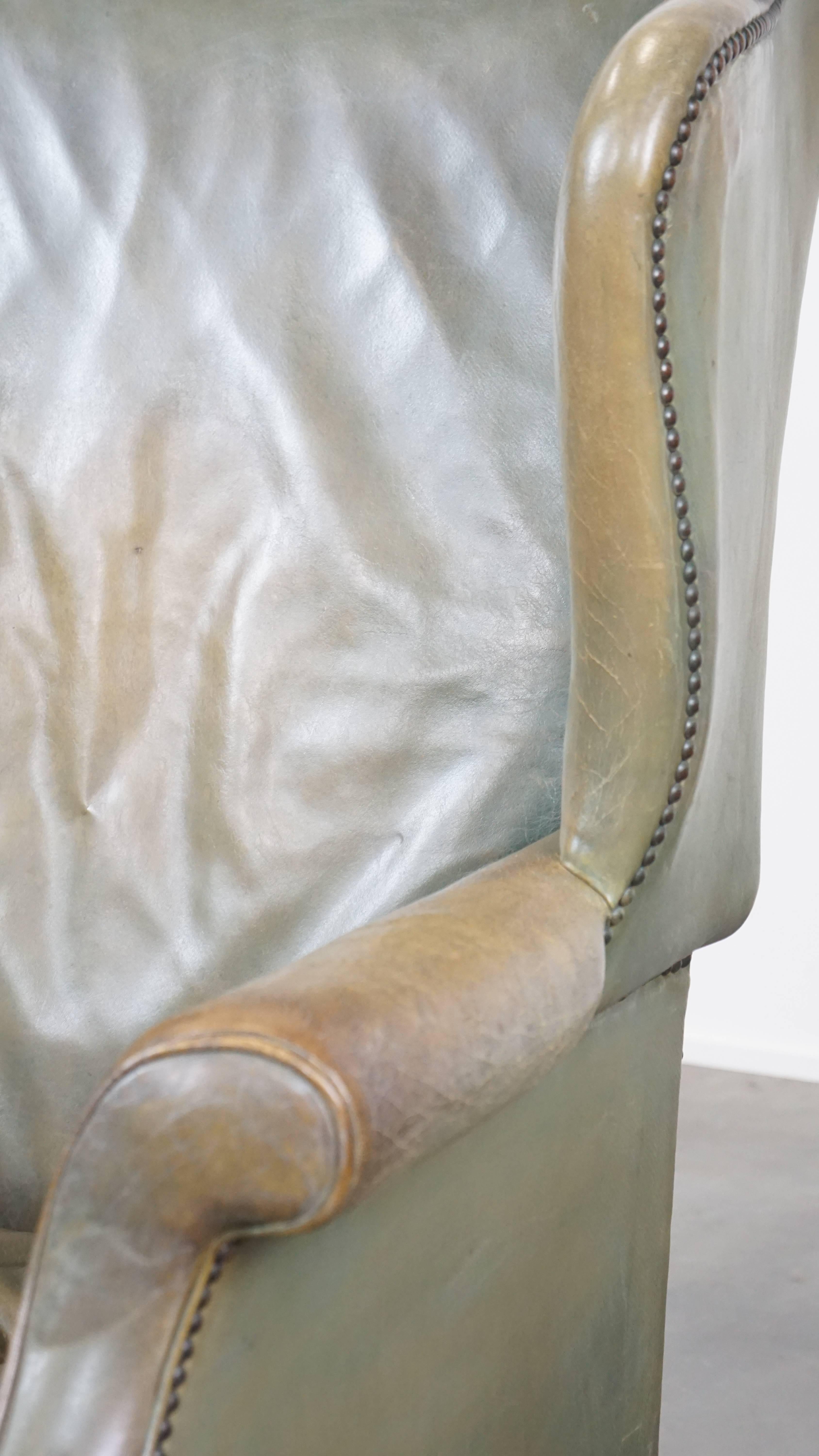 Unique and characterful green cowhide leather armchair with a beautiful patina For Sale 5