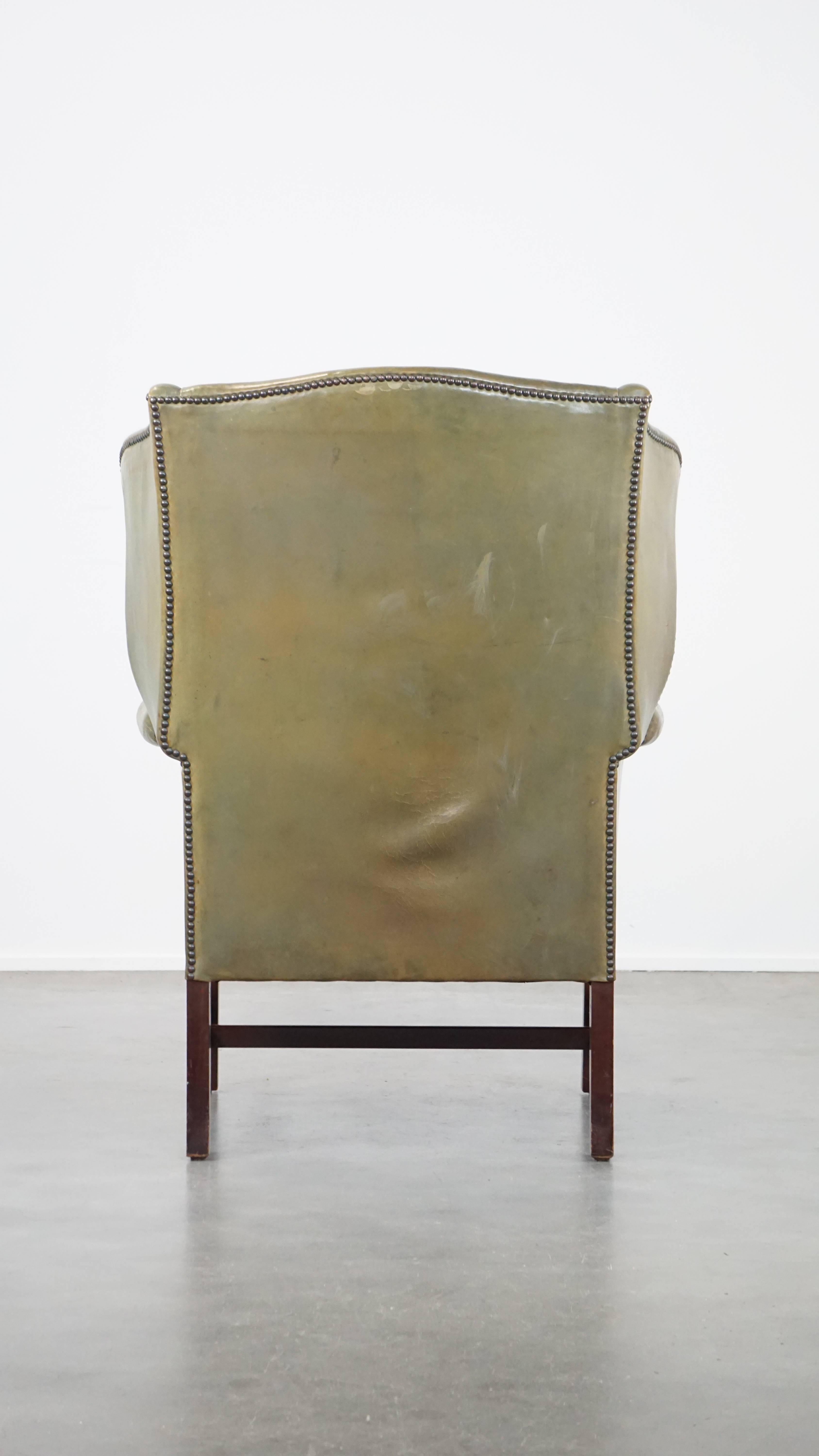 Unique and characterful green cowhide leather armchair with a beautiful patina In Good Condition For Sale In Harderwijk, NL