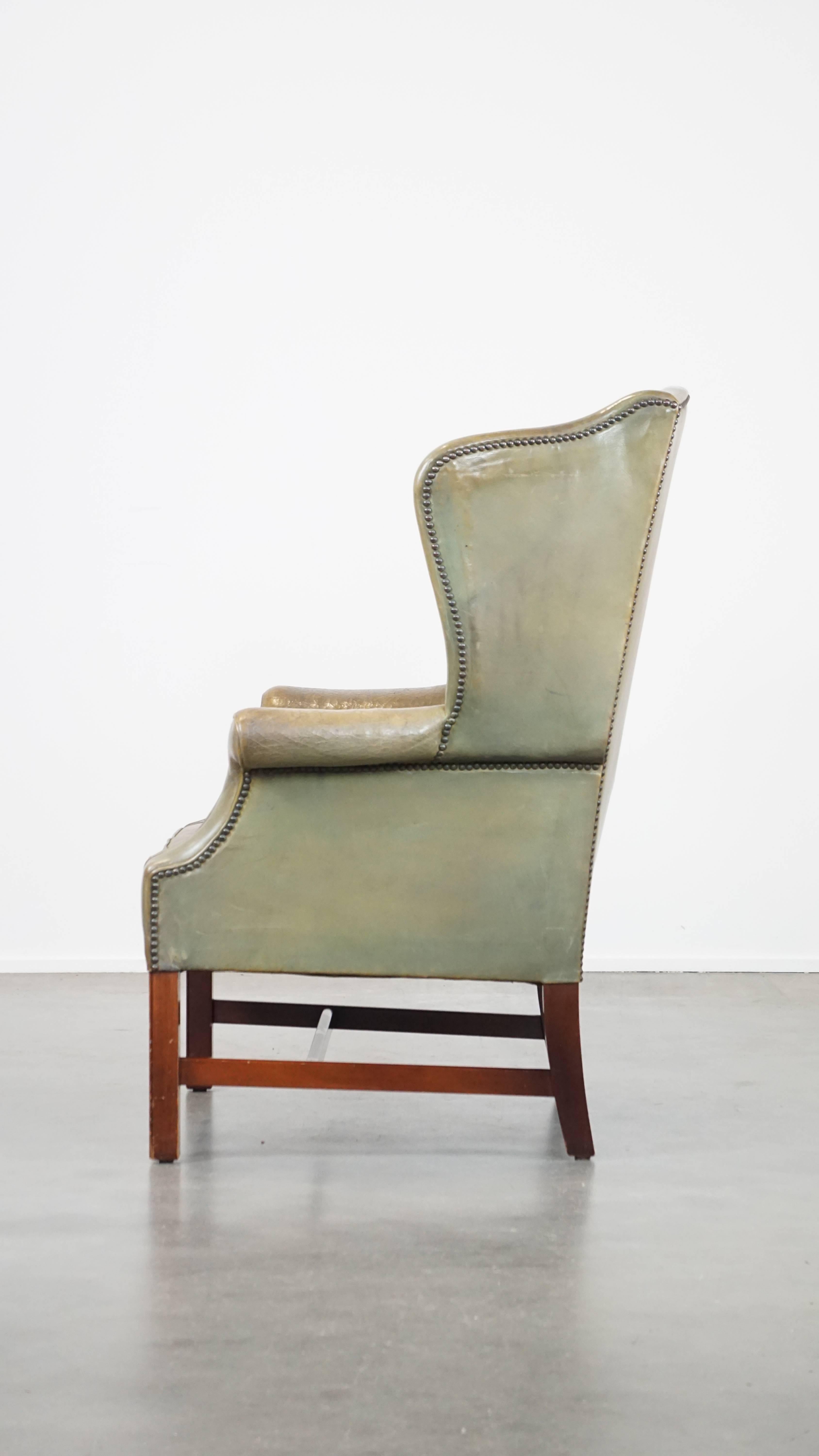 20th Century Unique and characterful green cowhide leather armchair with a beautiful patina For Sale