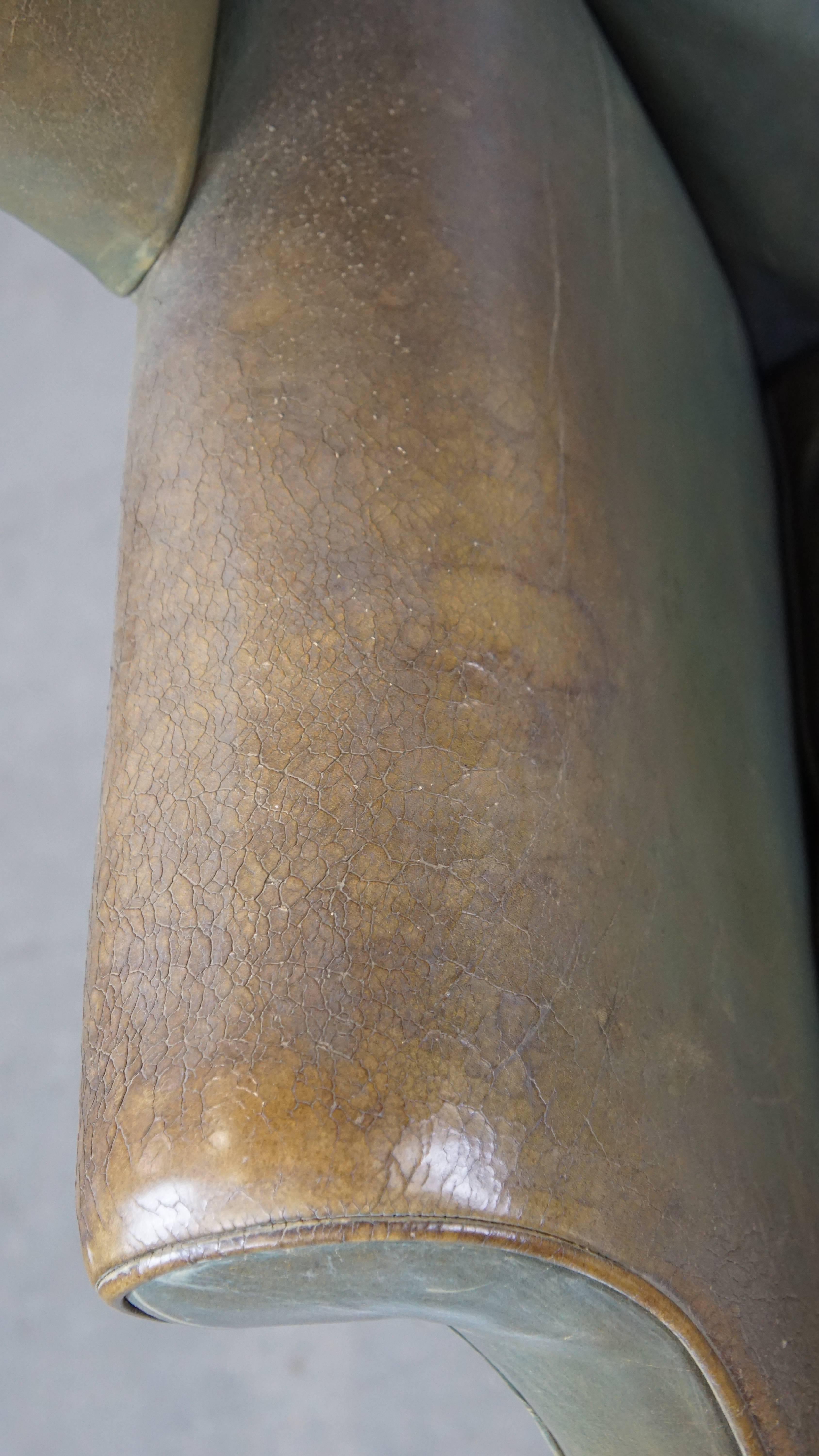 Unique and characterful green cowhide leather armchair with a beautiful patina For Sale 1