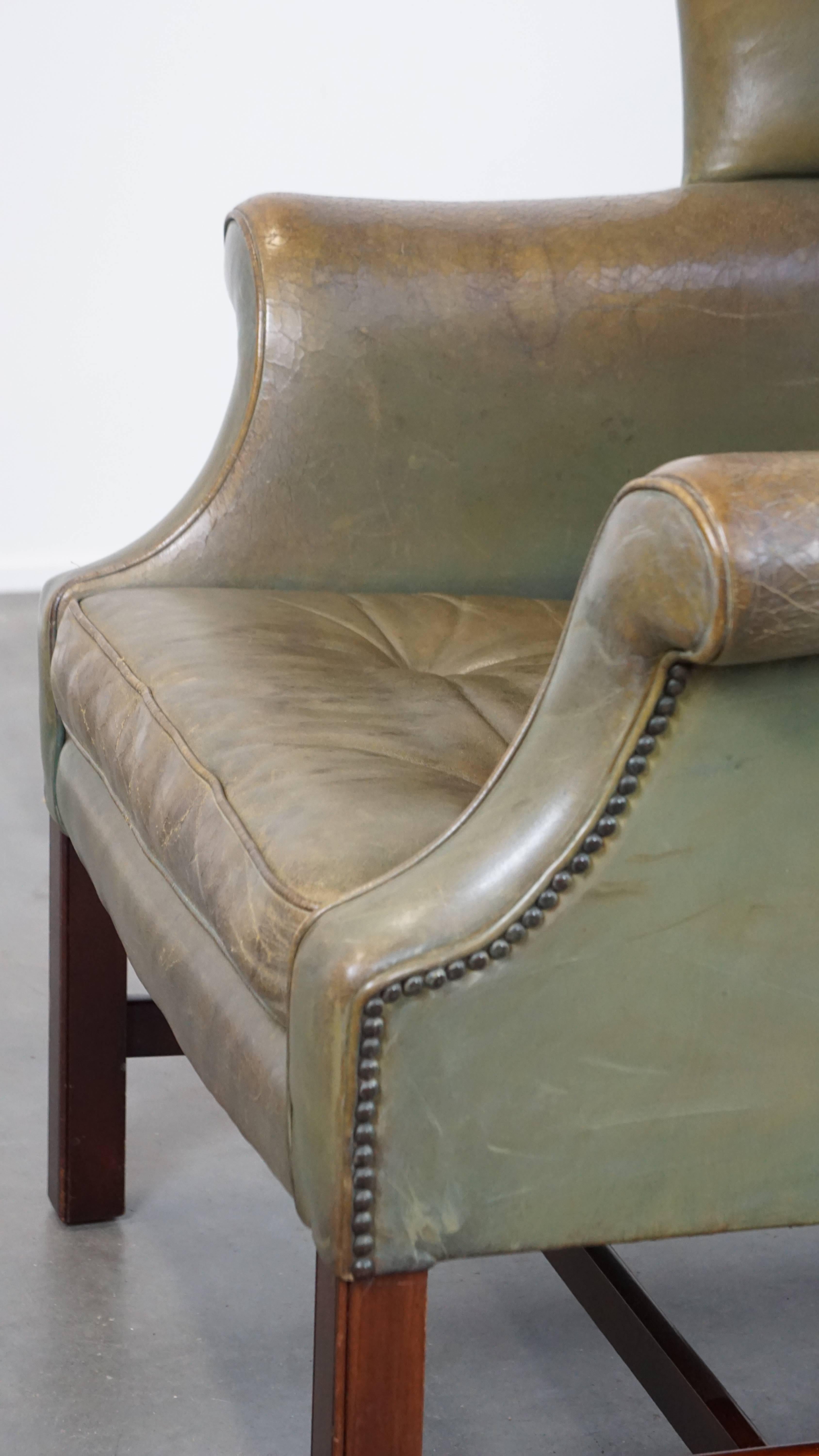 Unique and characterful green cowhide leather armchair with a beautiful patina For Sale 3