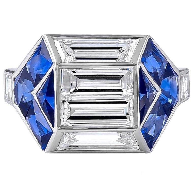 Art Deco inspired ring set in platinum that features a baguette center diamonds with the total weight of 1.18 carats along with blue sapphires with the weight of 0.99 carats and small diamonds on the side with the weight of 0.34 carats.