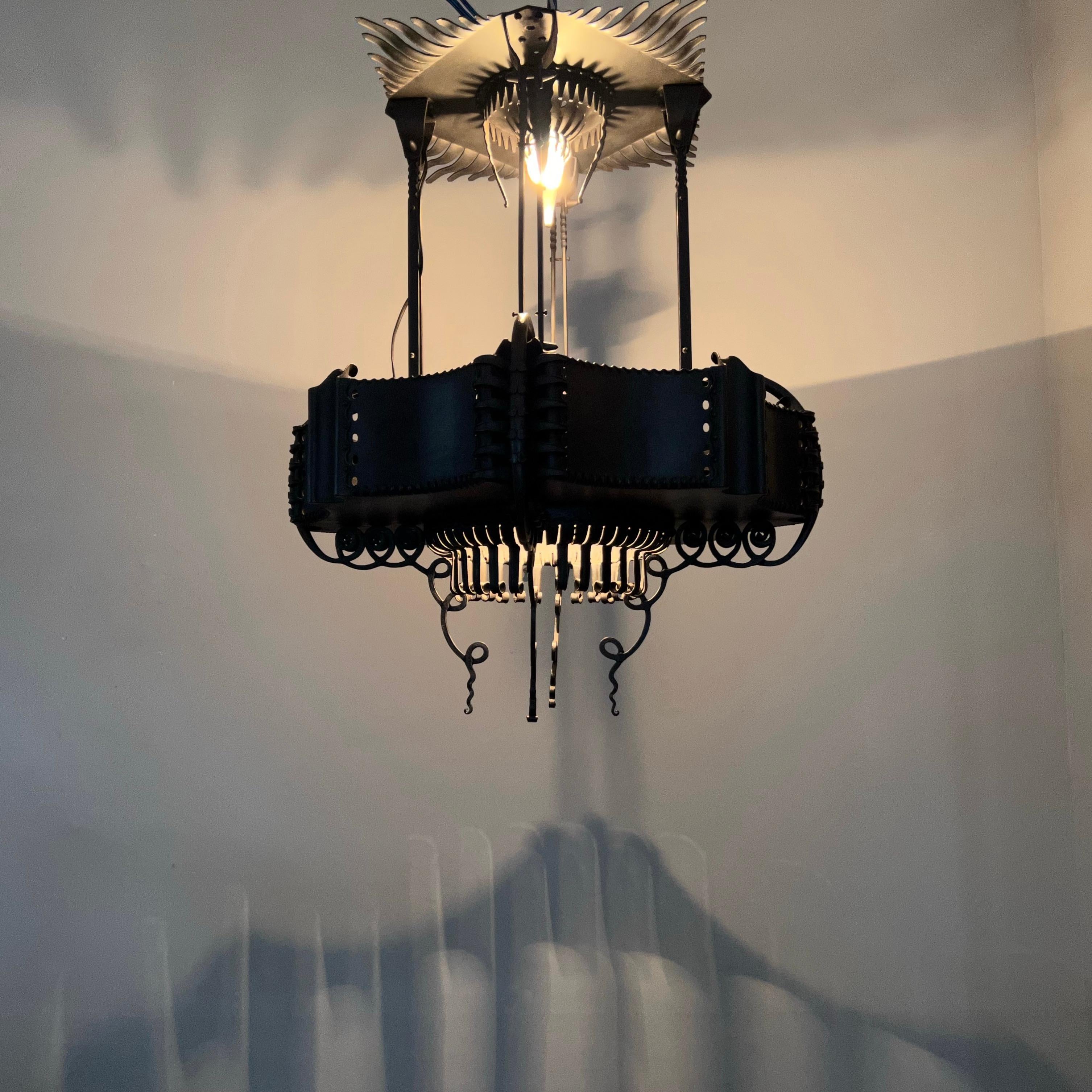 Amazing and skillfully made, Dutch Amsterdamse School wrought iron pendant light.

Michel de Klerk (1884-1924) is considered the most important architect and designer of the Dutch Amsterdam School era. His designs were and still are among the most