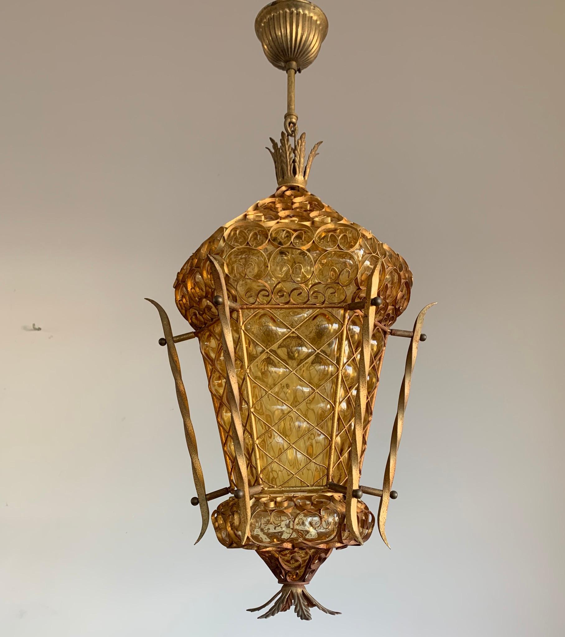 Remarkable and great condition Venetian light fixture with amber colored glass.

This near antique Venetian pendant is not only one of the largest we ever had the pleasure of offering, it also is a truly unique design. We have completely rewired