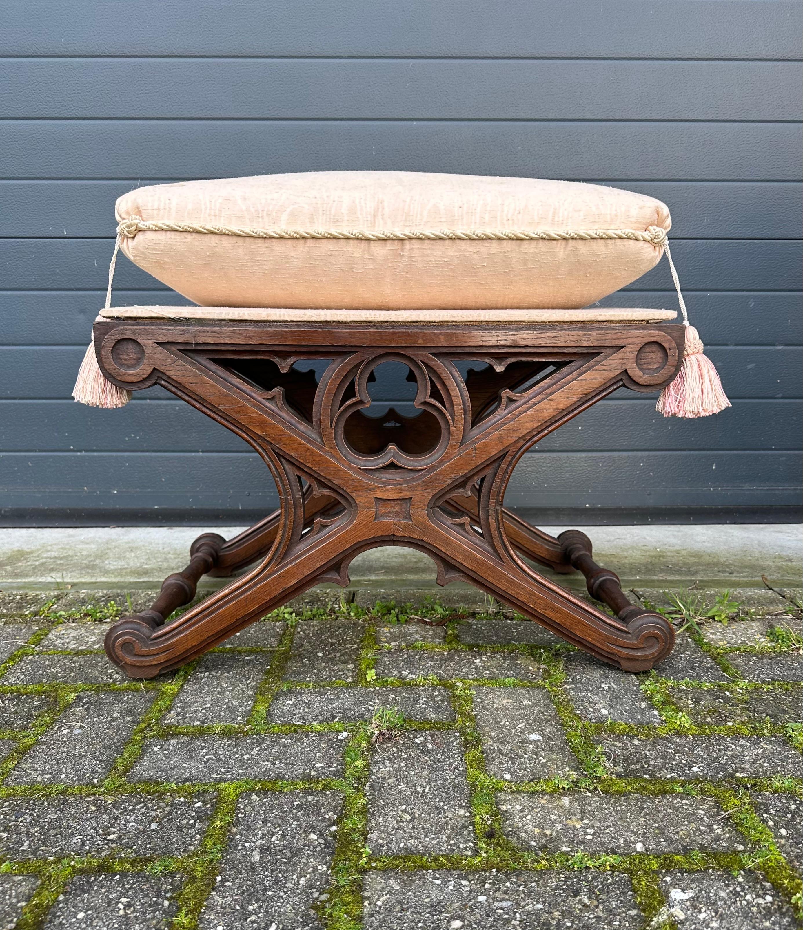 Antique, stunning and practical Gothic stool with a seat pillow with tassels.

This striking and perfect size Gothic stool is as stable as the day it was handmade & hand-carved and the woodwork is in excellent condition. All handcrafted out of solid
