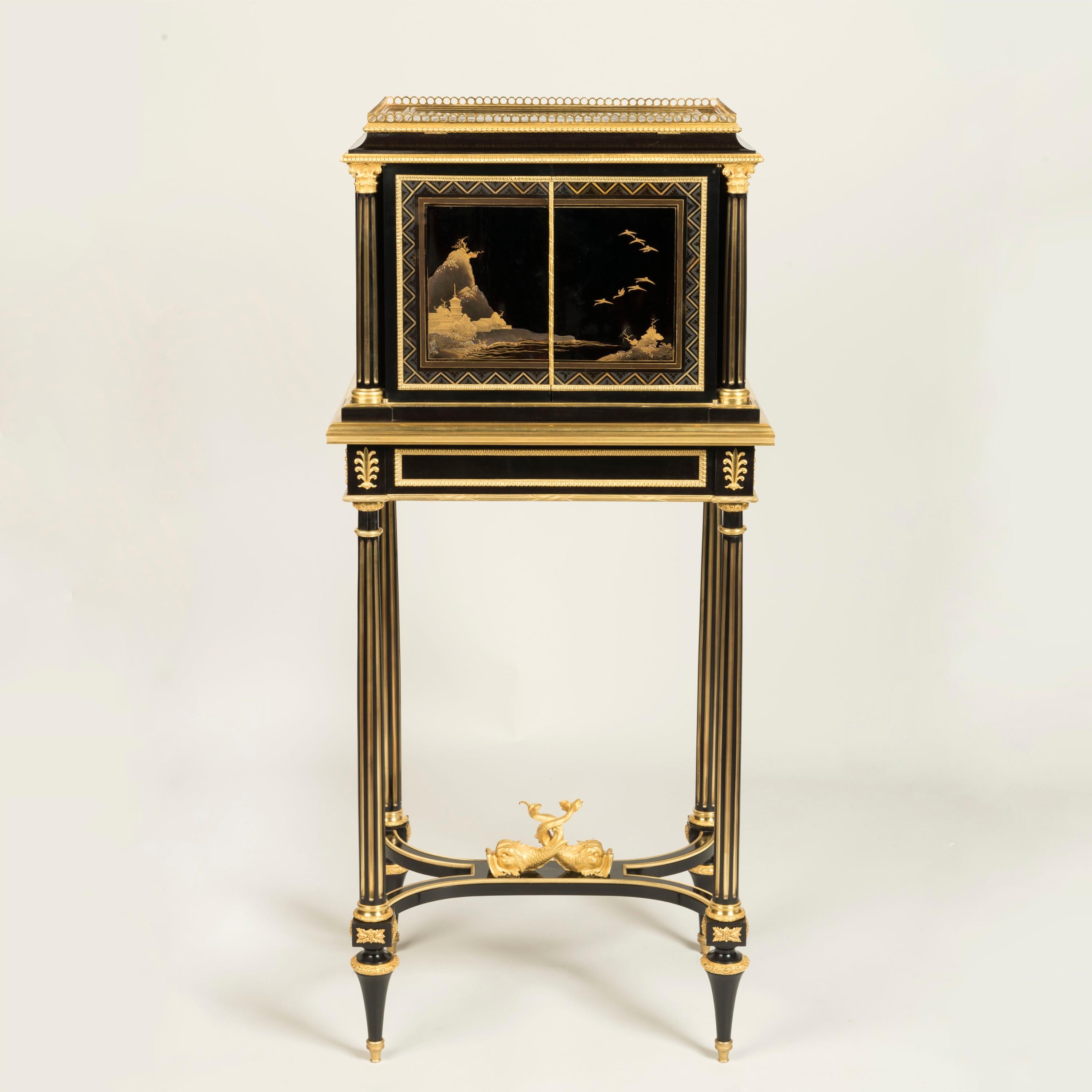 An Exceptional Lacquer Cabinet on Stand,
Signed and dated by Henry Dasson
 
Rising from toupie feet, conjoined by an addorsed swept stretcher, centred with intertwined ormolu dolphins, issuing four fluted brass inset columns of entasis form, capped