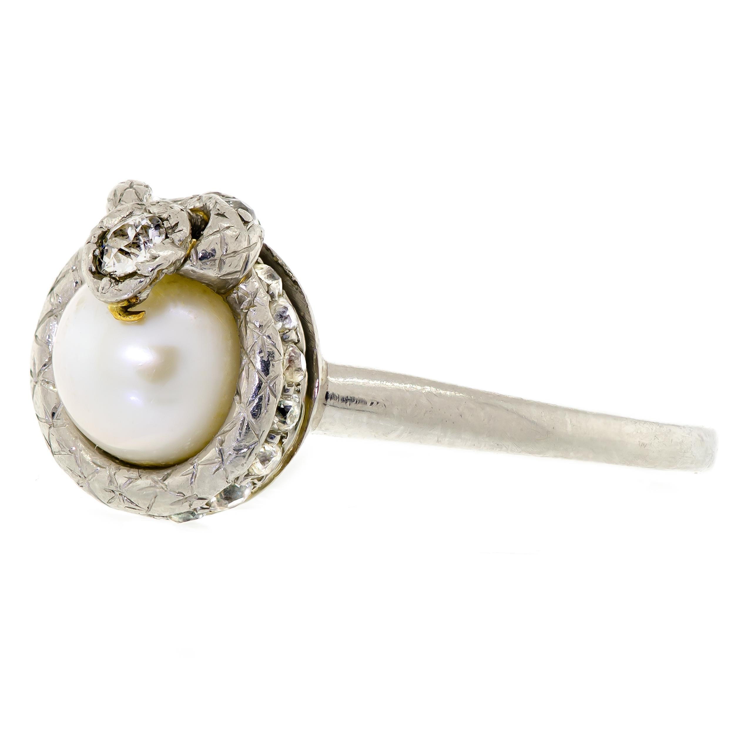 Unique and rare platinum diamond and pearl (not tested for origin) vintage snake ring circa 1925 - centrally with one pearl with diamond headed snake sitting ontop whose body is coiled around and holding the pearl - diamond border - old full cut