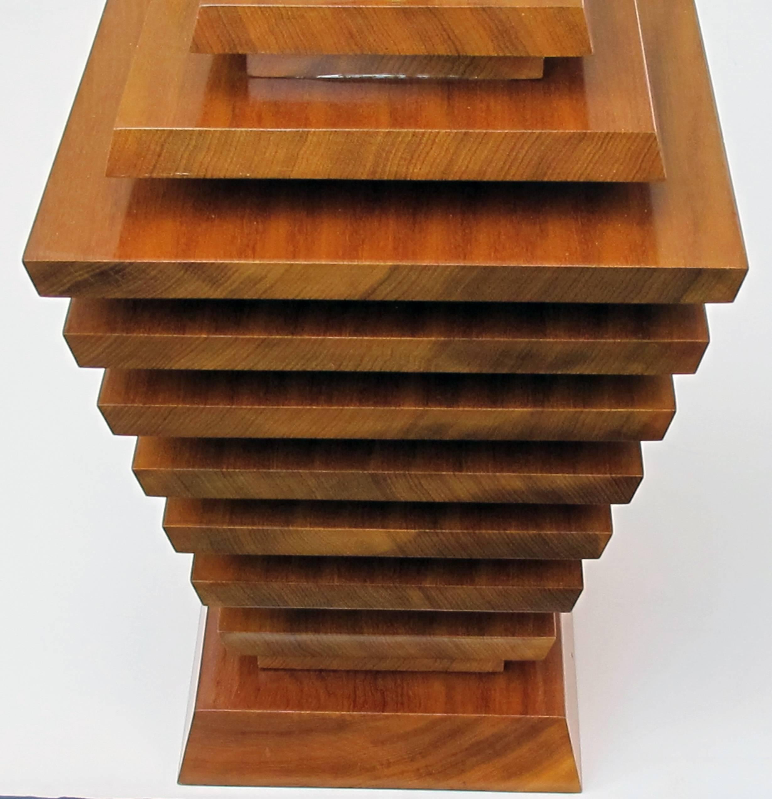 A truly unique and stylish pair of American 1960s stacked maple lamps of tapering form; fantastic statement pieces, each of large-scale consisting of stacked, richly-colored maple panels with bevelled edges, tapering to the base.