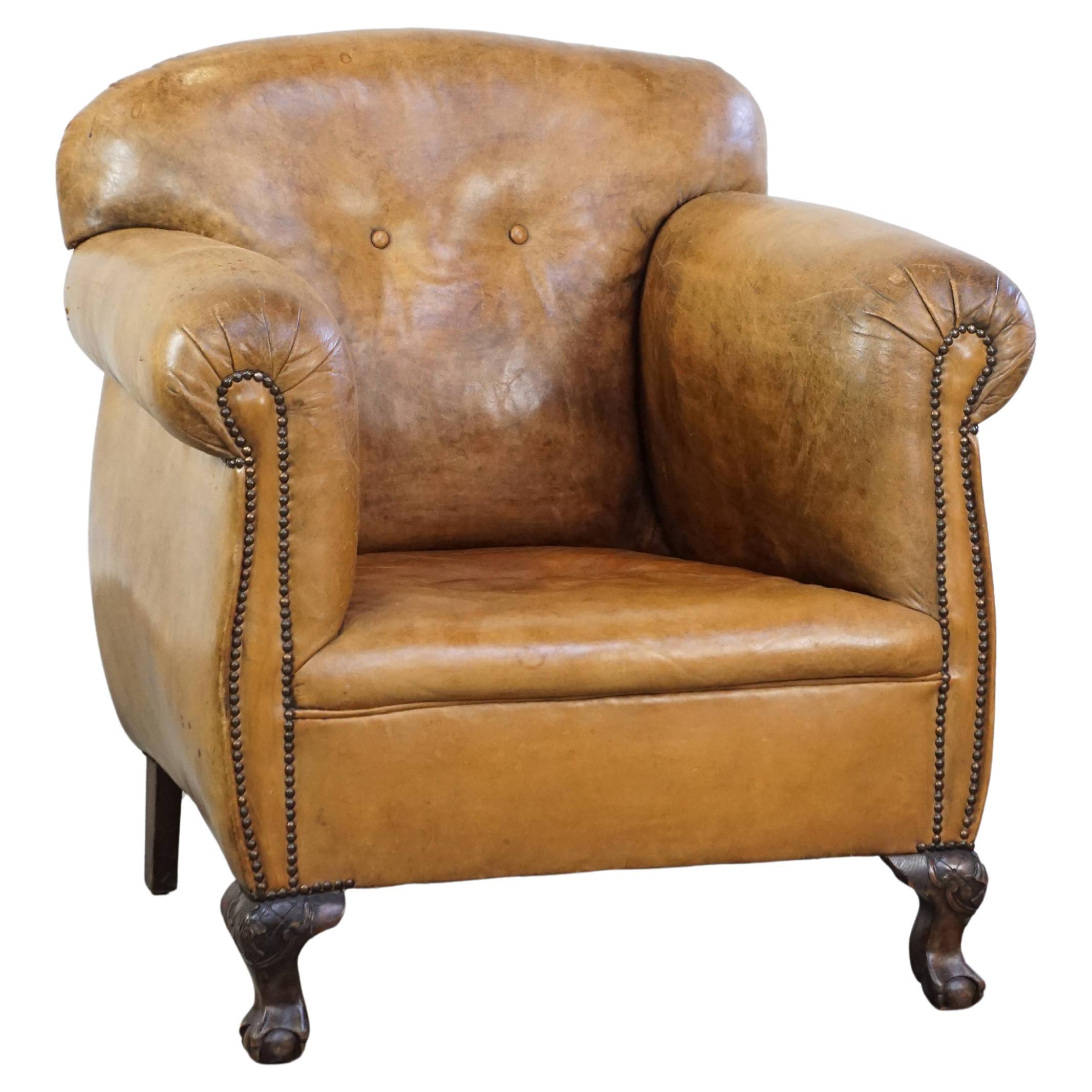 Unique antique armchair made of sheepskin with beautiful, elegant legs