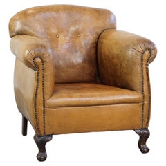 Unique antique armchair made of sheepskin with beautiful, elegant legs