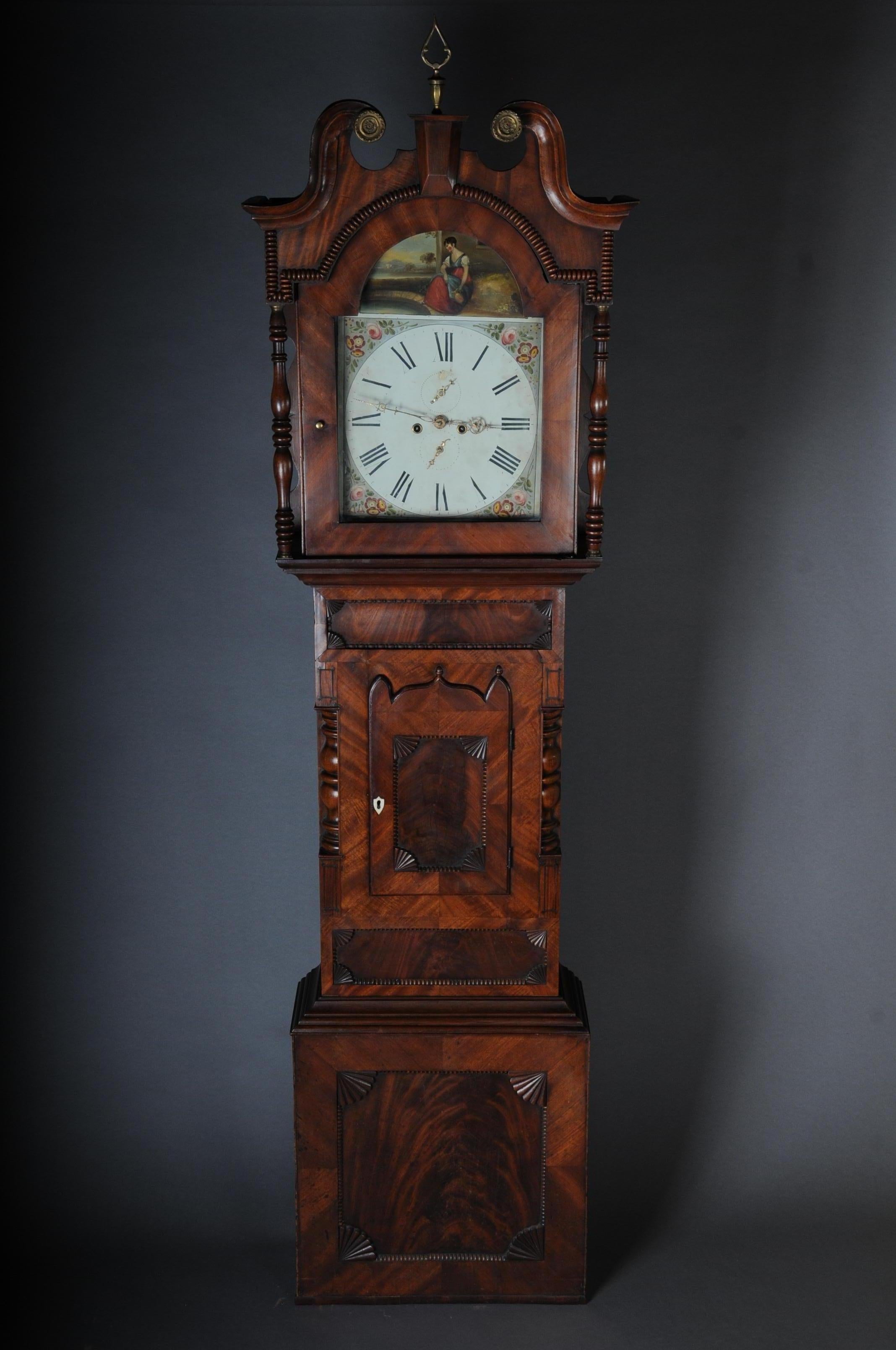 Unique antique English grandfather clock, mahogany, 18th century.

English floor clock, 18th century, mahogany veneer with root wood mirror, bead bar strips, turned columns, white dial with Roman numerals and gold-plated hands, polychrome flower