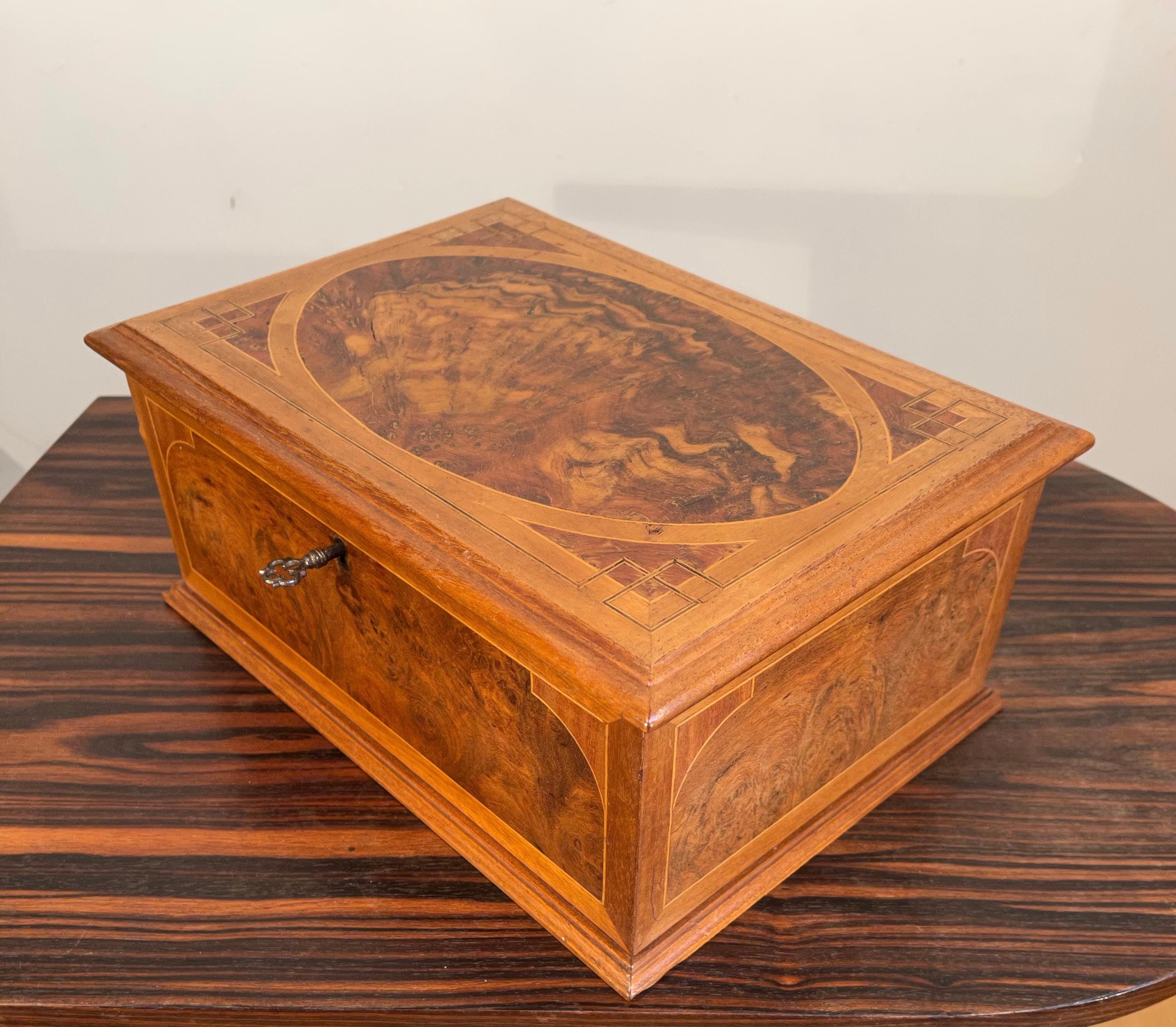 Great craftsmanship with a great Patina from the early 1900s inlaid with Wood and other woodtypes.

If you are looking for a stylish and truly decorative box to grace your table or dresser then this antique gem could be yours to own and enjoy soon.