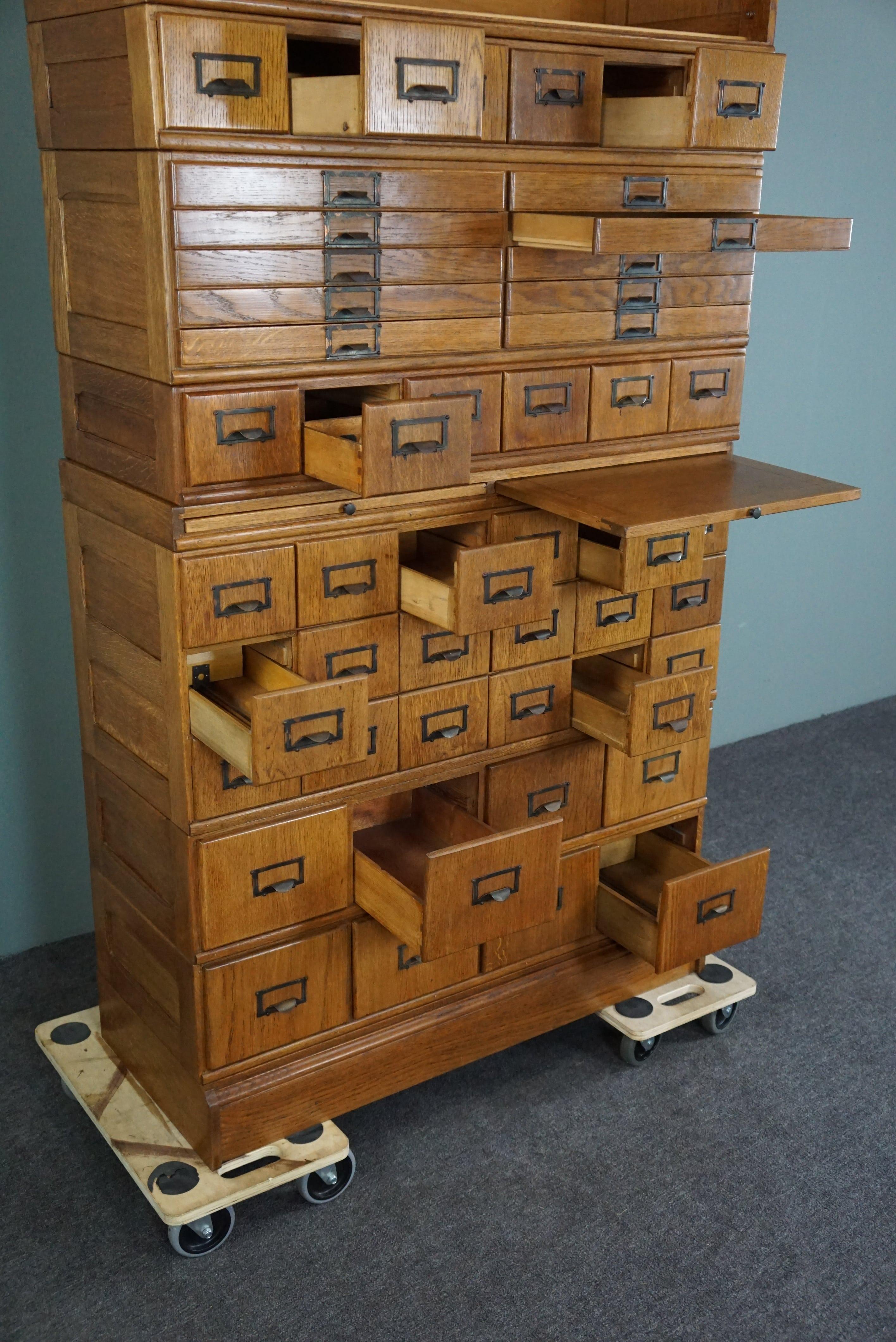 20th Century Unique antique oak pharmacy cabinet full of storage options, early 1900s For Sale