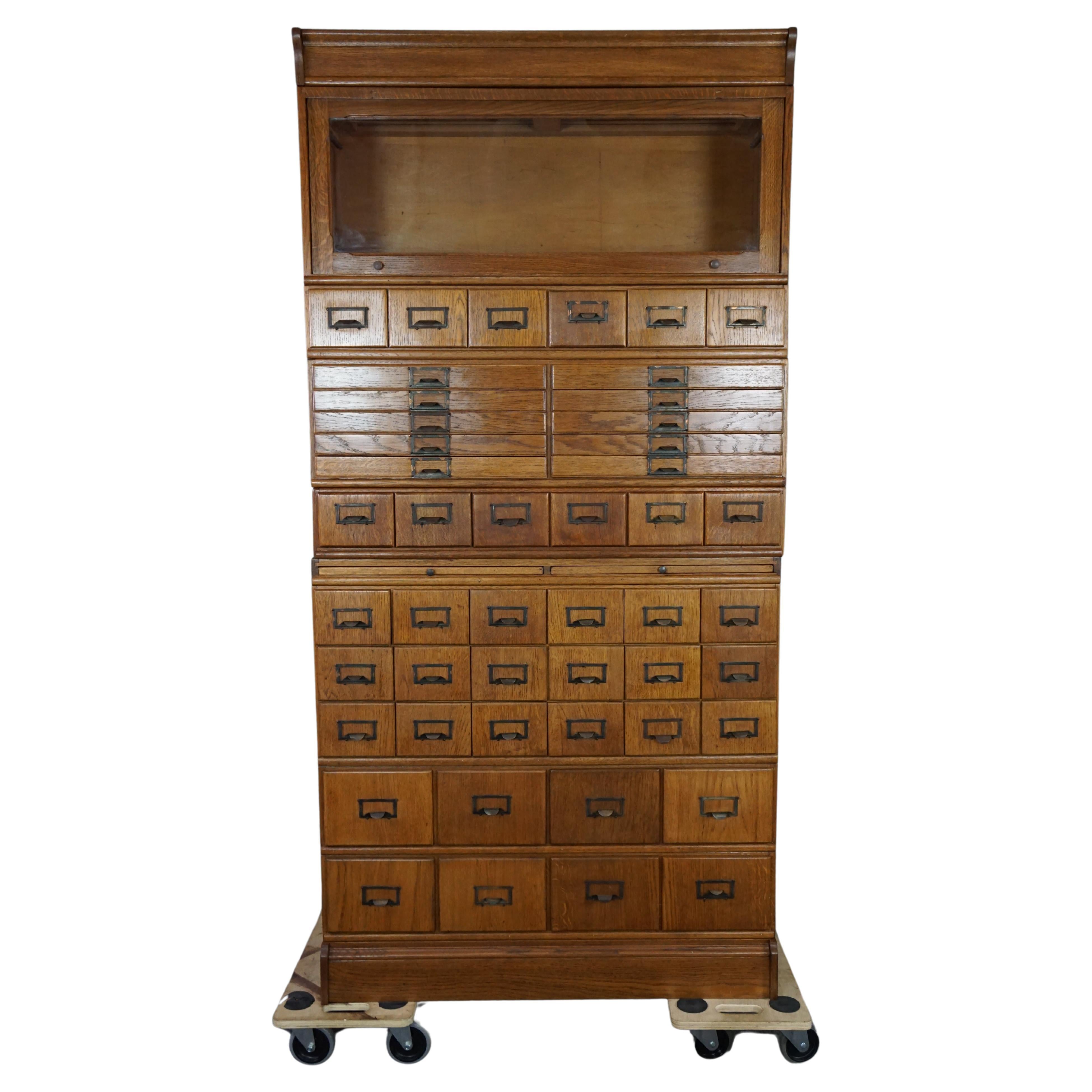Unique antique oak pharmacy cabinet full of storage options, early 1900s For Sale