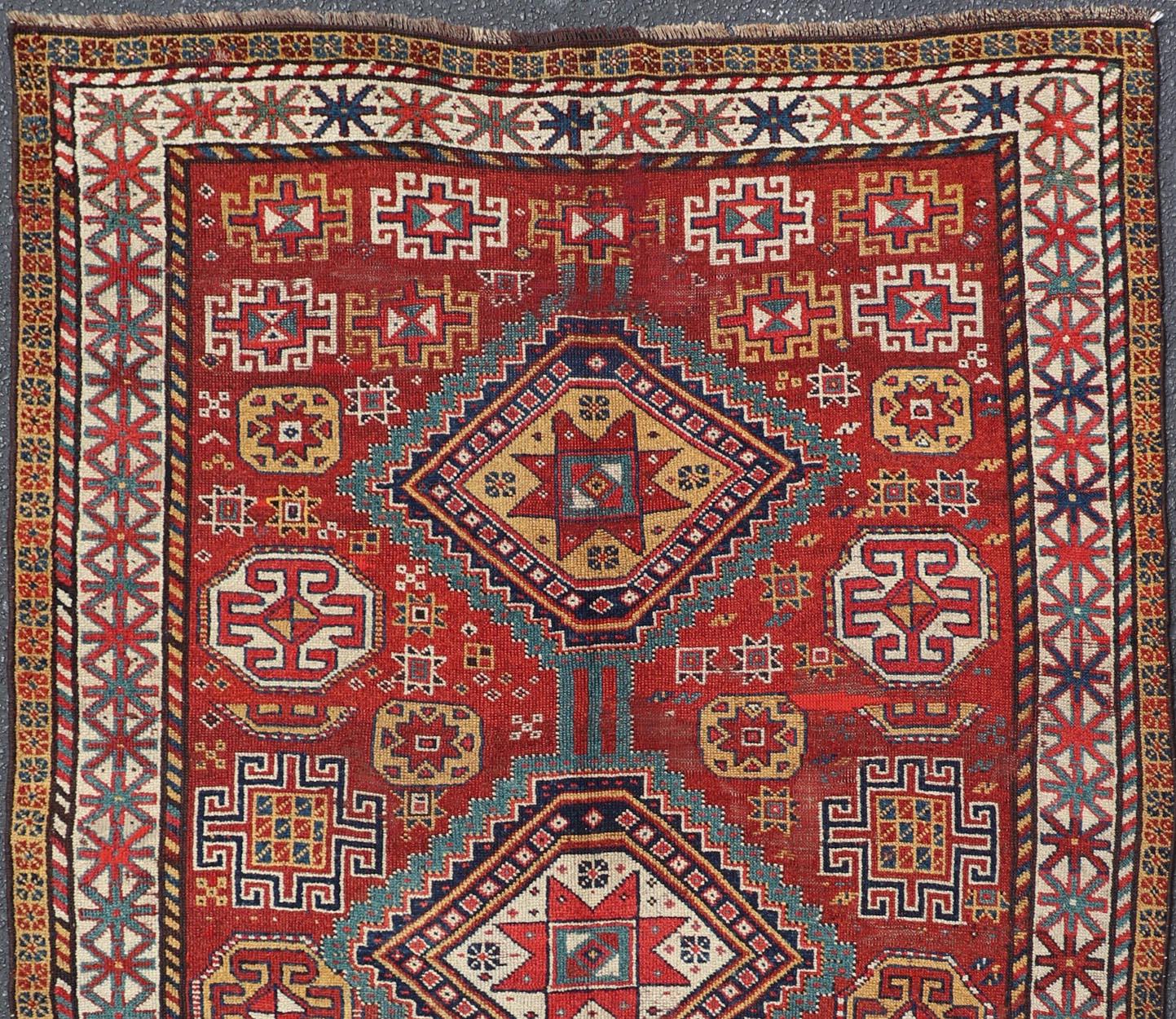 Unique antique Qashqai rug with geometric motifs in red, blue, and golden yellow, rug #S12-0518. 
 This stunning 19th century Qashqai rug from the central region of Persia displays three magnificent, geometric central medallions and an all-over
