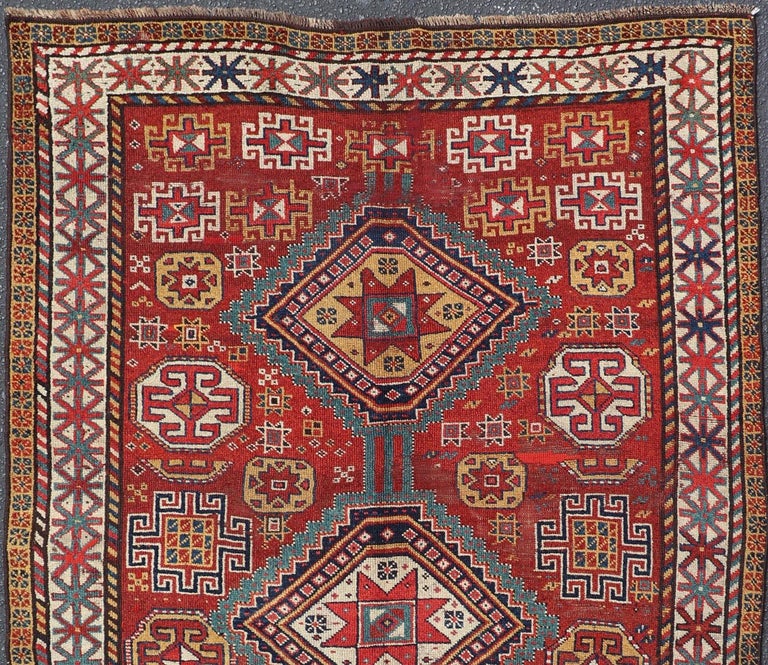 Unique antique Qashqai rug with geometric motifs in red, blue, and golden yellow, rug #S12-0518. 
 This stunning 19th century Qashqai rug from the central region of Persia displays three magnificent, geometric central medallions and an all-over