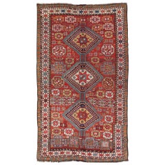 Tapis Qashqai ancien unique à motifs géométriques en rouge, bleu et jaune doré