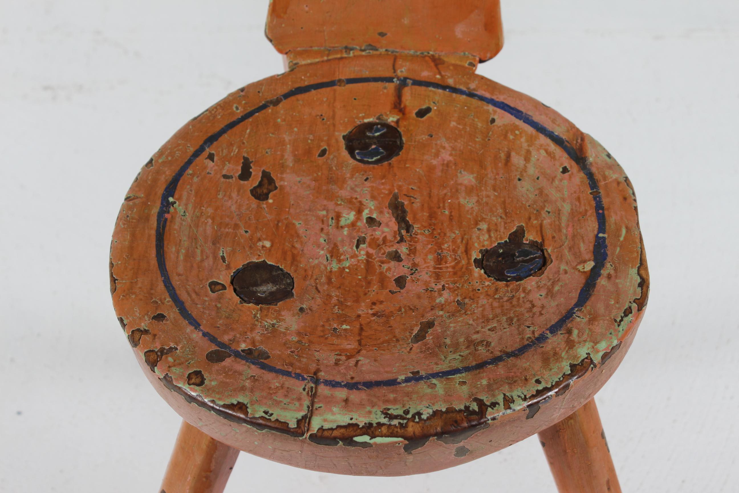 Charming unique piece of furniture!
Sculptural Antique Swedish 3-legged chair made of solid wood with patinated surface of remaining paint. 
A cut out heart in the backrest gives the chair great personality.

Perfect as a decorative eye catching