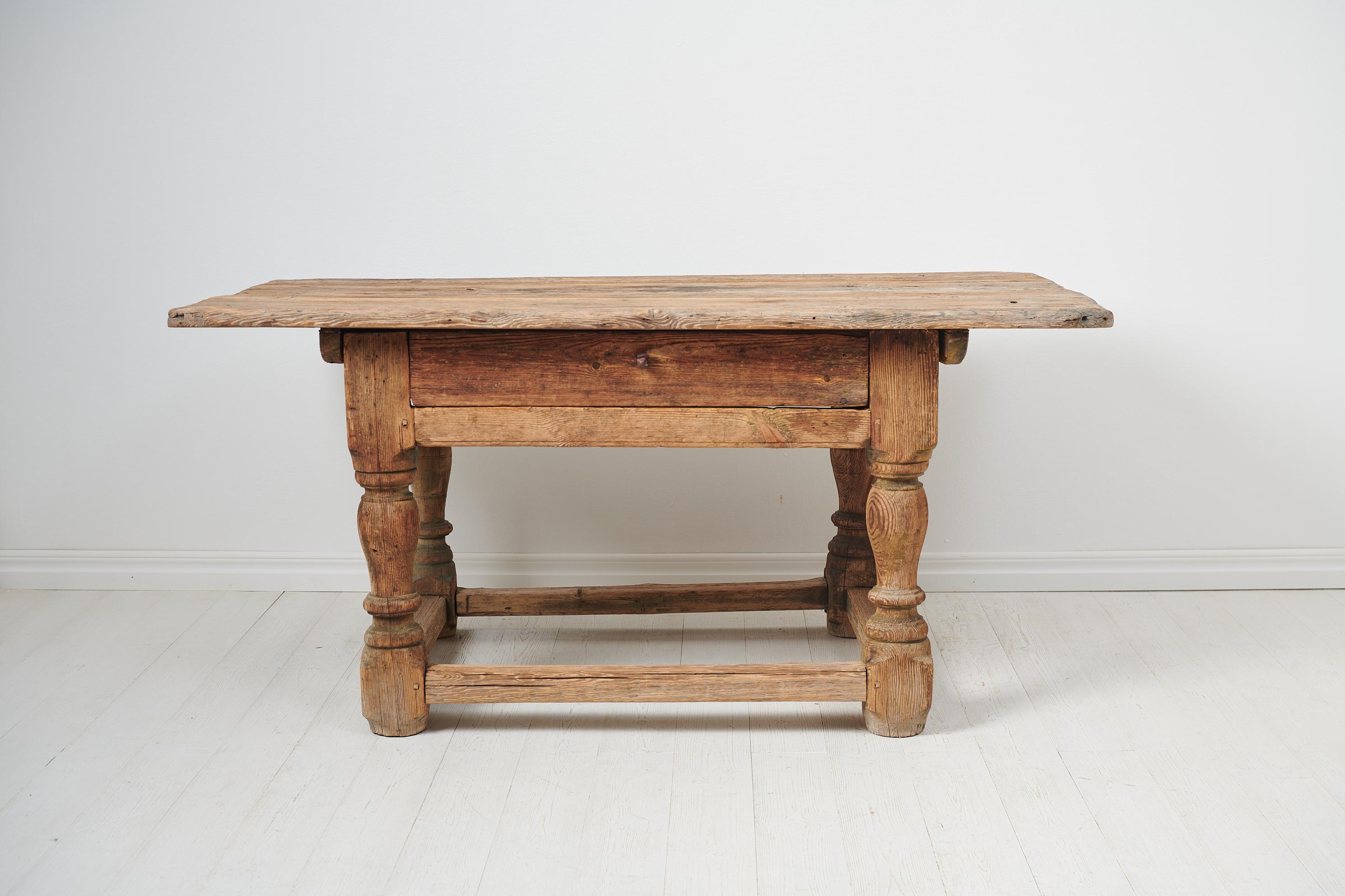 Unique Swedish Baroque table made by hand during the mid 1700s. The table is a very rare example of early Swedish furniture and has a frame in pine with heavy, solid lathed legs. The table has a fantastic patina as the surface has been left