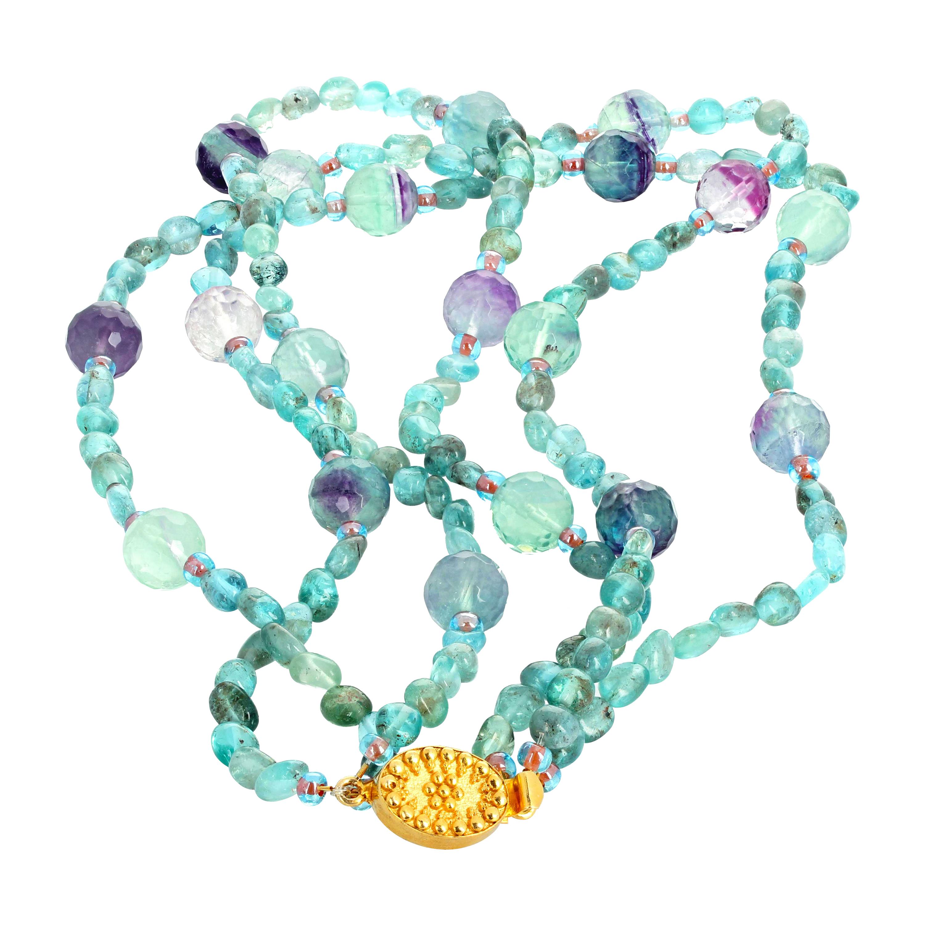 Gorgeous glowing brilliant bluegreen natural precious Apatite (approximately 6.5 mm) enhanced with checkerboard gem cut natural Fluorite rondels (approximately 12 mm) set in this triple strand twistable necklace with gold plated easy to use clasp.