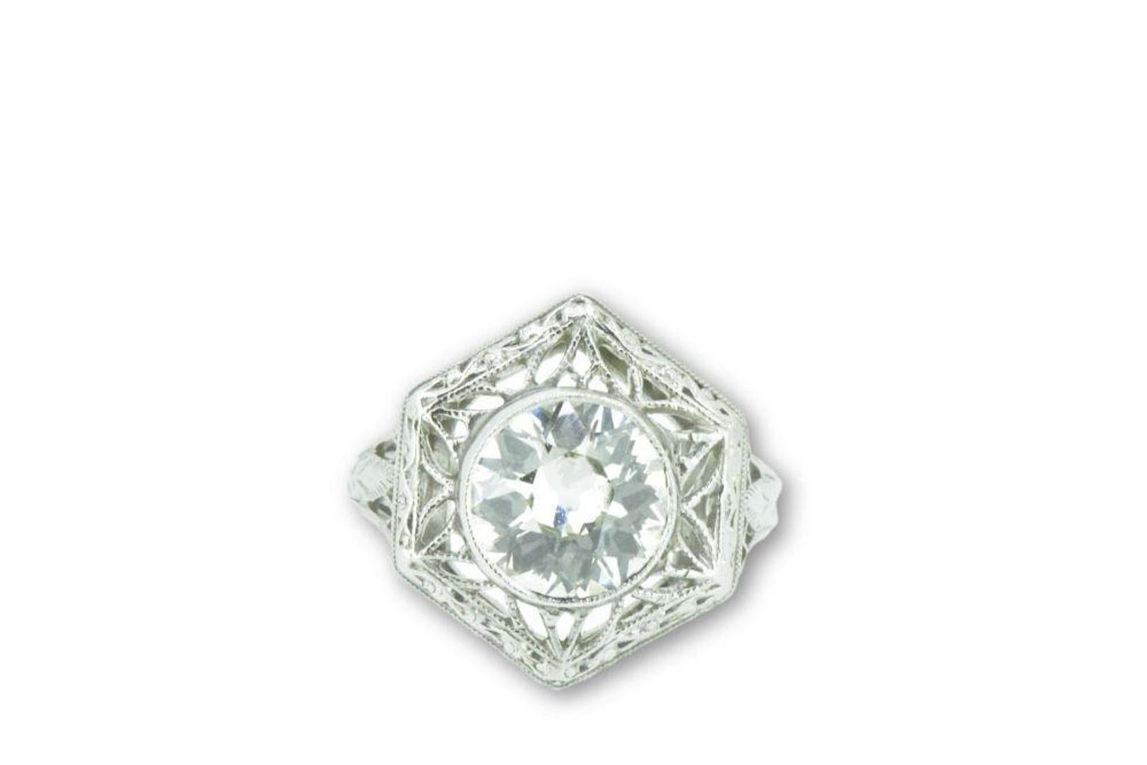 Centering an old European cut diamond  weighing 1.19 carats, L color and VS1 clarity

Striking Art Deco platinum mount featuring a geometric filigree design with hand engraved details

Ring Size: 3 1/2 & Sizable

Top measures 14.6 mm and sits 5.1 mm