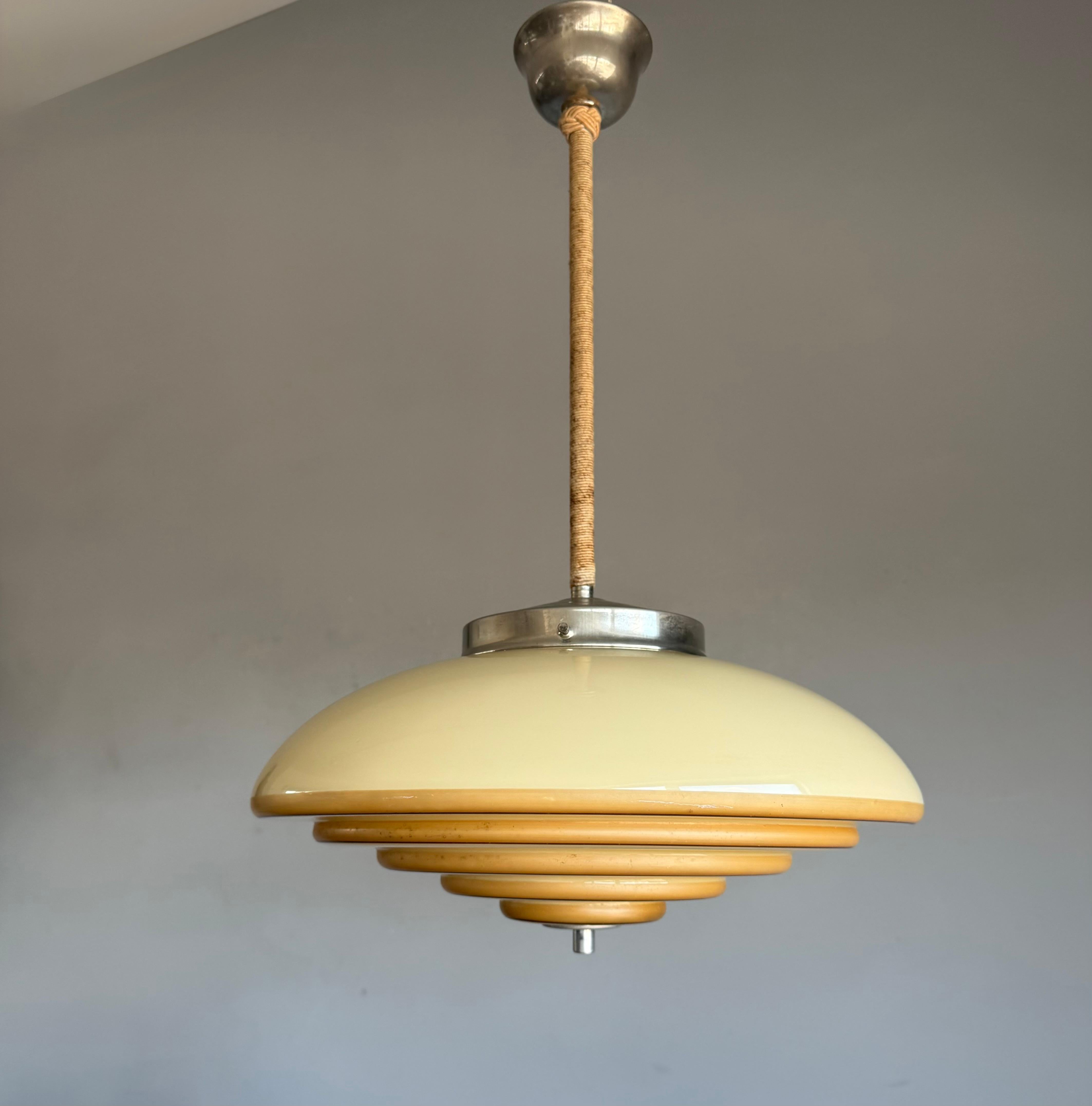 Another top quality, antique pendant light with the wow factor.

This unique, good size and stylish color Art Deco fixture from the heydays of the European Art Deco era will bring class, style and the most beautiful warm light in your living space.