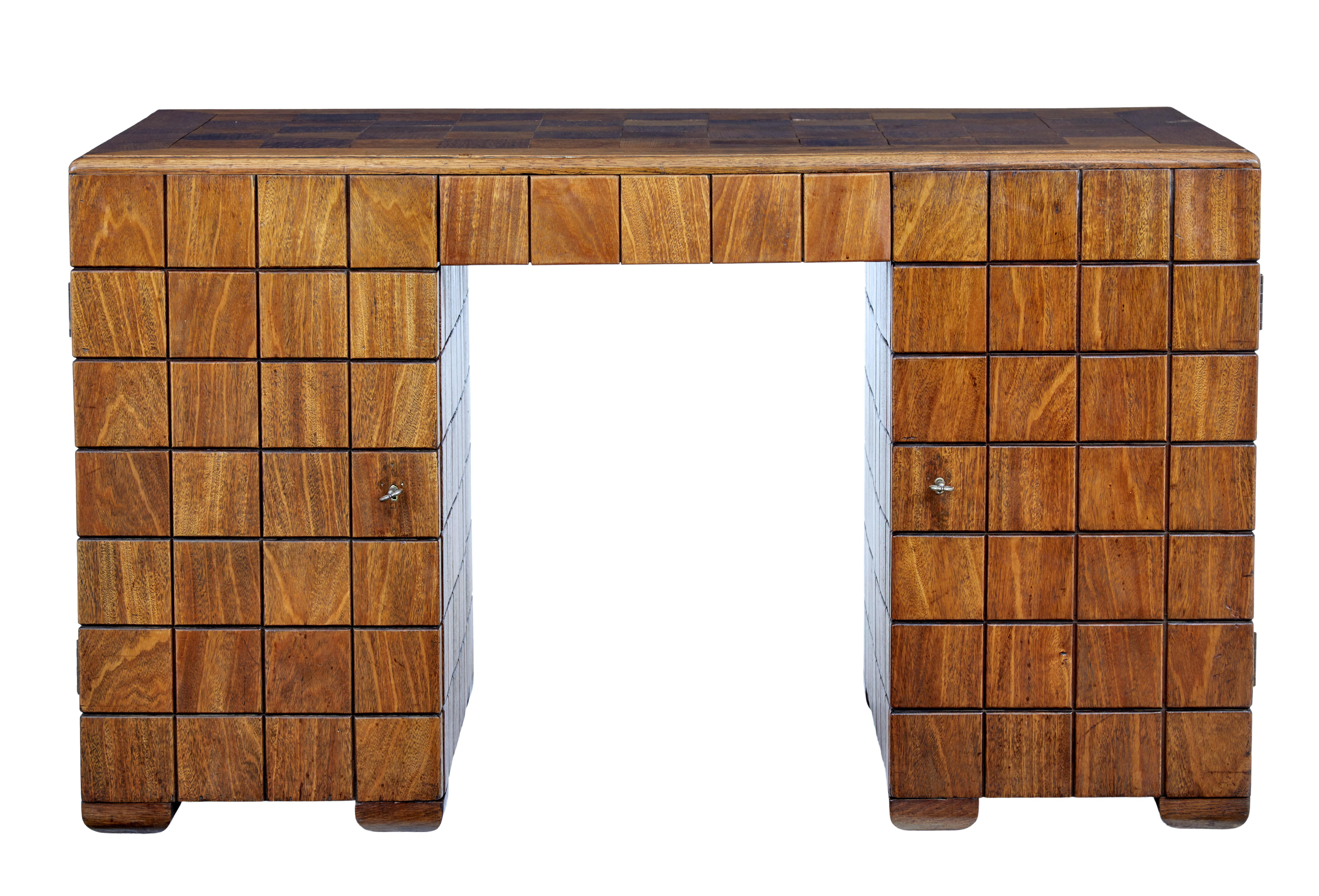 We are pleased to offer this unique rare Art Deco period desk circa 1920.

Made in 1 piece. Writing surface laid with square blocks of solid teak surrounded by border. The panelled effect continues all around the pedestals and reverse which makes
