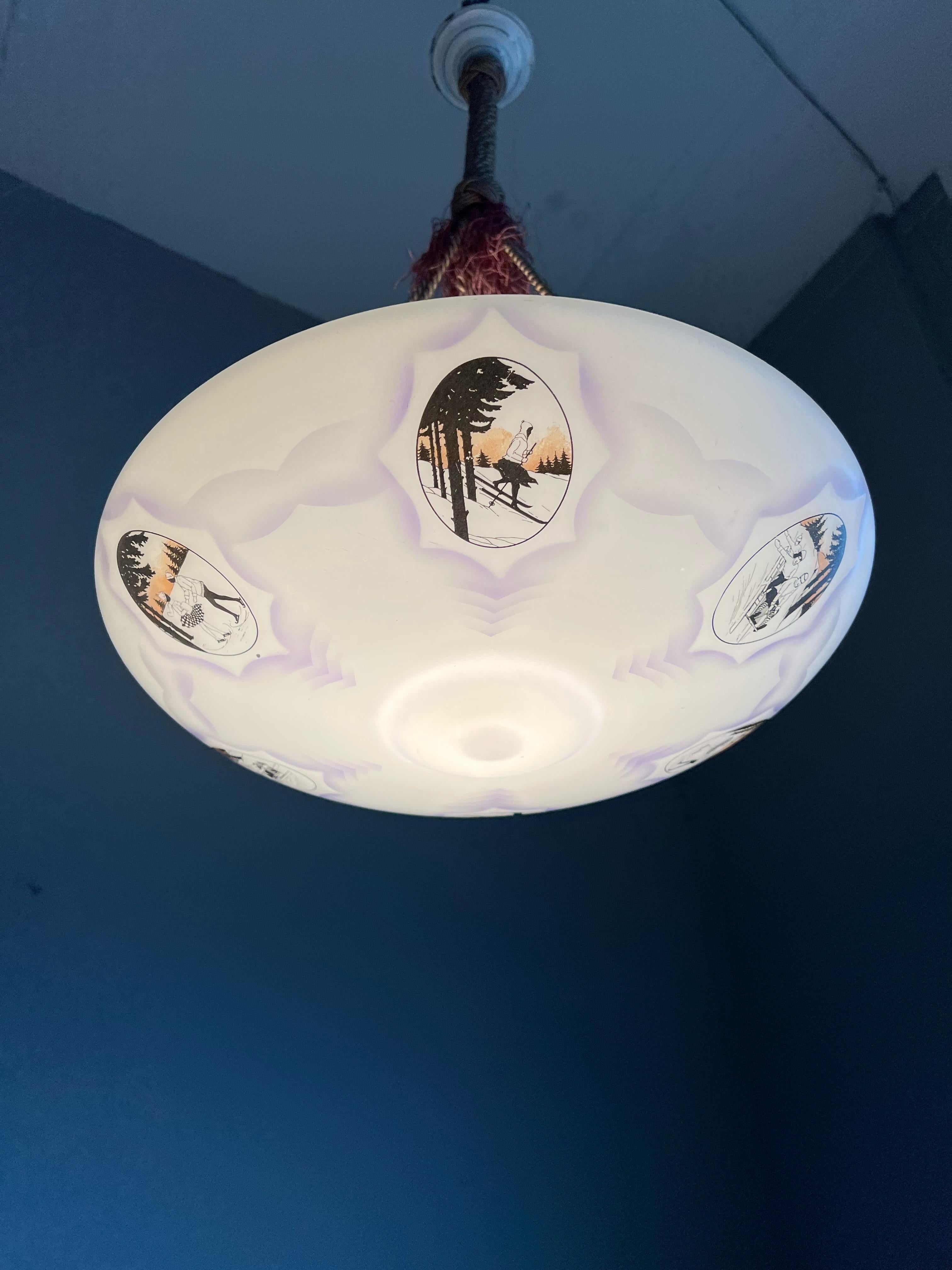 Unique and stunning work of lighting art.

If you are passionate about early 20th century decorative art in general and about the outdoor winter sports (and fun) in particular then you will love this very rare, art glass light fixture. What you