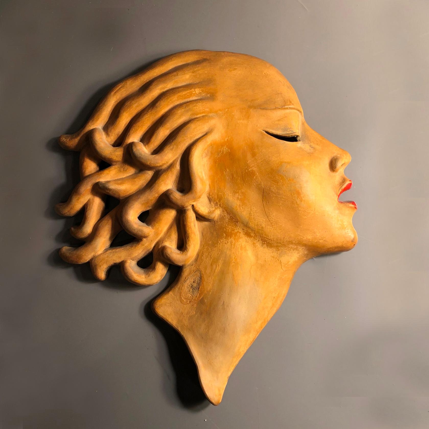 Art Deco period mask, terracotta cold painted.
Dr Rank Rezso was a ceramist working between the two world wars.
The most successful of his works were the wall masks.