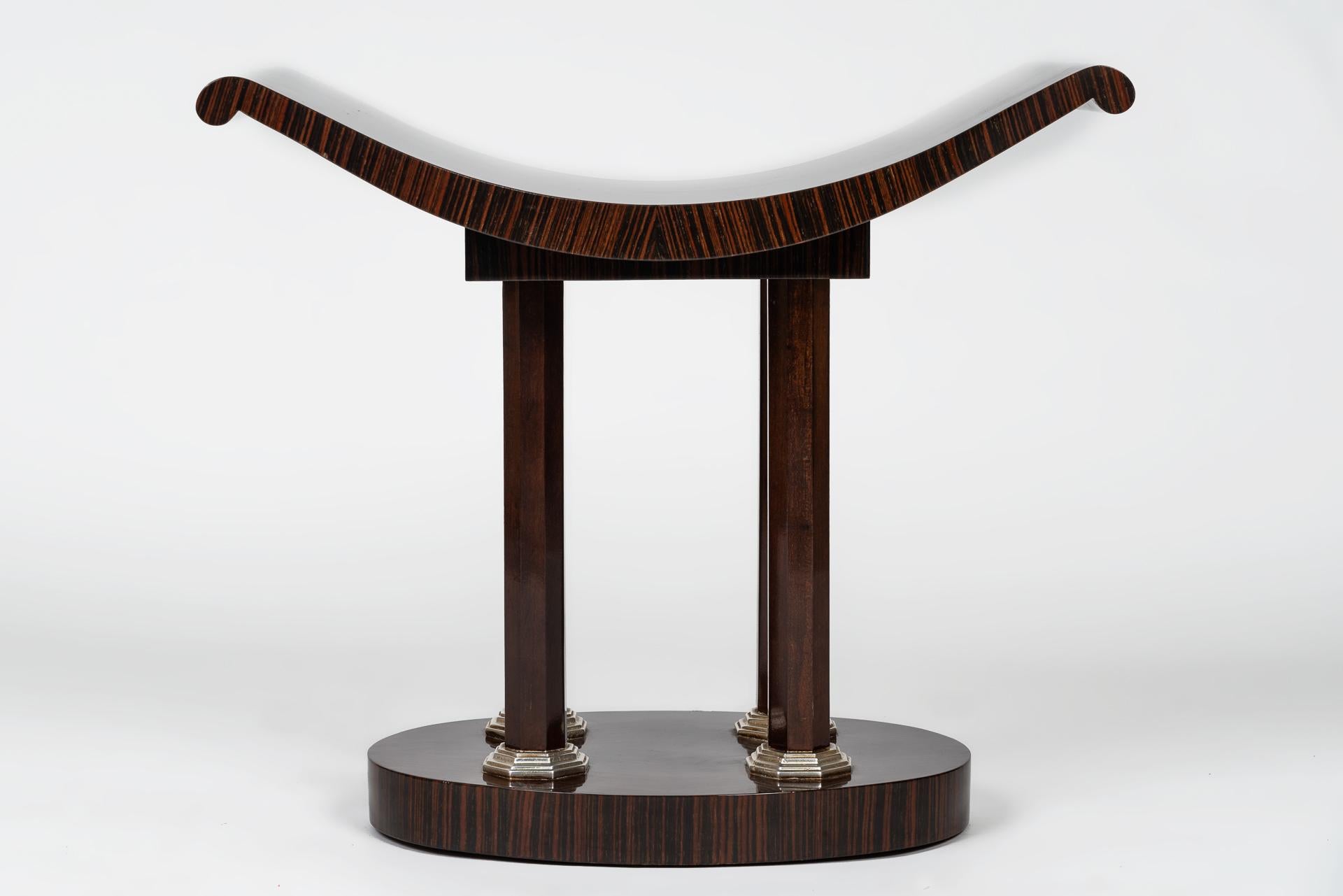 This beautiful Art Deco stool was designed by E. Gray for the manufacture of EVE in Italy. It is especially beautifully crafted in the grain of ebony. The wood grain has been mirrored 4 times to create a beautiful pattern on the seat and the