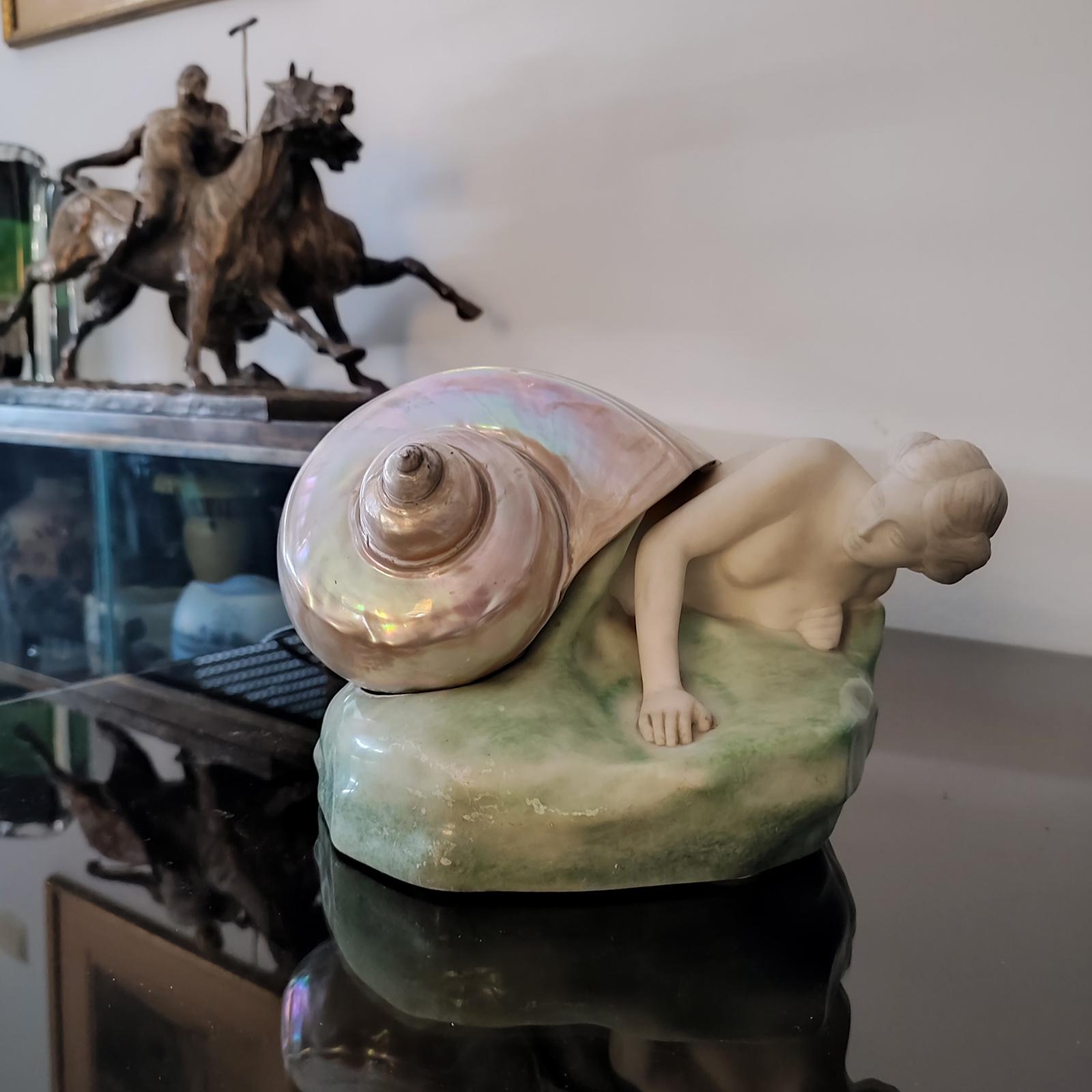 Unique Sculpture Lamp “The Snail Girl”, Berlin / Germany ca. 1910.
An alabaster and shell (turbo marmoratus) figural lamp made by Rosenthal and Maeder (R.u.M), designed by the Italian sculptor Valmore Gemignani. 
The bottom is marked with a bronze