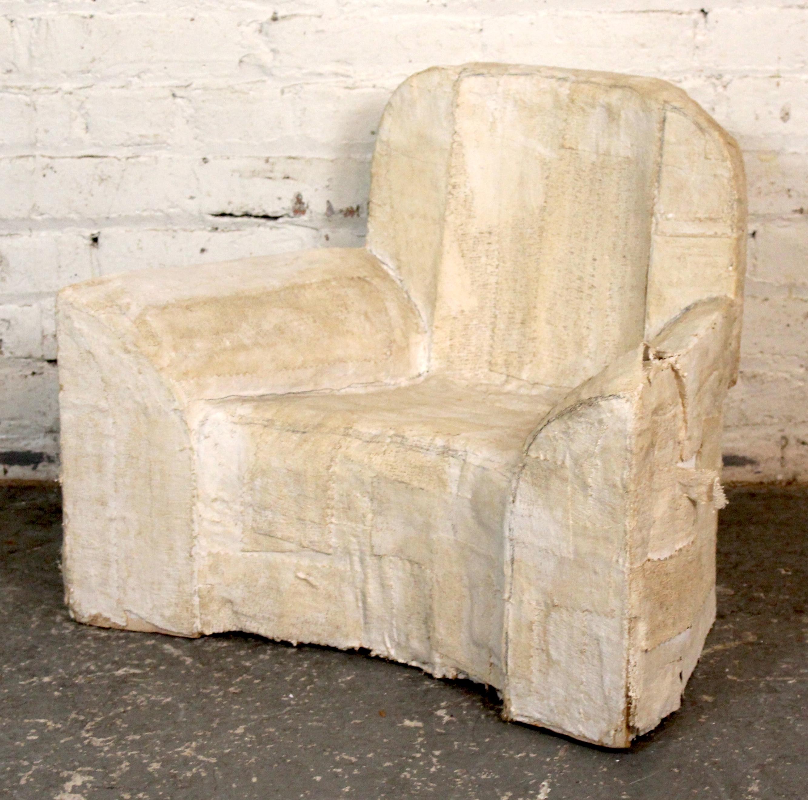 Playful and thought-provoking, this small chair sculpture is crafted from papier-mâché over a Styrofoam core. Blending form and concept, it evokes the shape of a functional chair while existing purely as an artistic object. A compelling piece that
