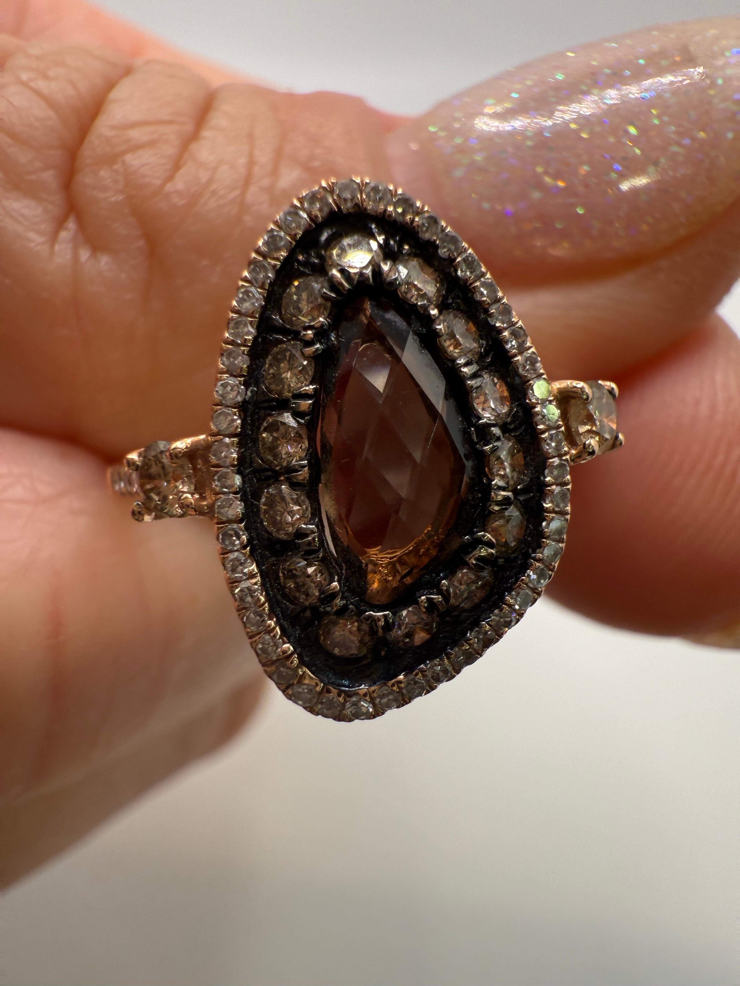 A unique artistic diamond ring with smoky quartz in the center and 0.52 carats of diamond halo, very intriguing design and very comfortable on hand, made in 14KT gold.  Weighs 2.7 grams.

**All items leave our premises with a certificate in buyers