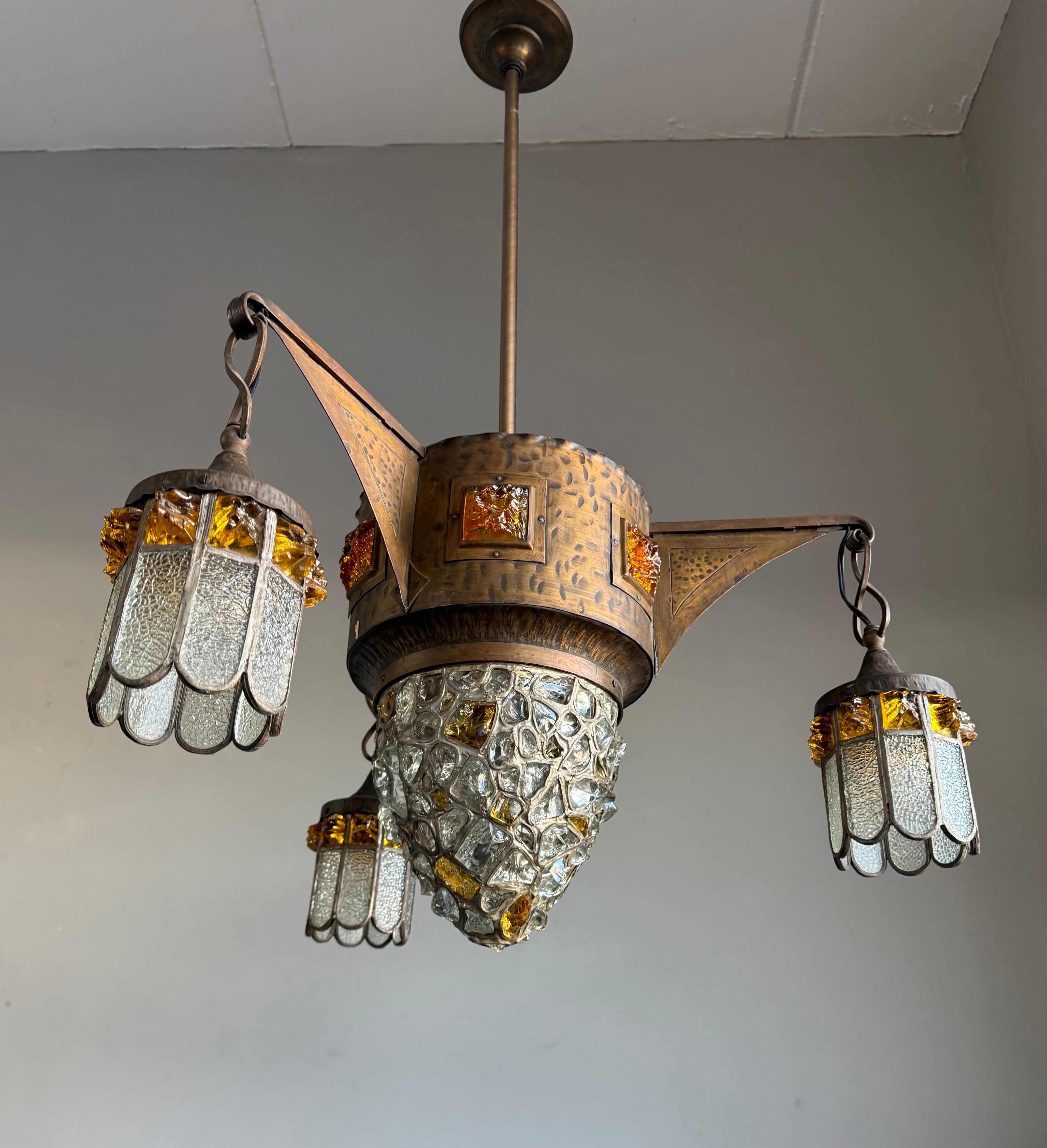Good size, marvelous design and truly stylish inlaid 'chunky glass' ceiling fixture.

With early 20th century light fixtures being one of our specialities, finding a unique Arts and Crafts pendant always makes our heart jump. Every designer knows
