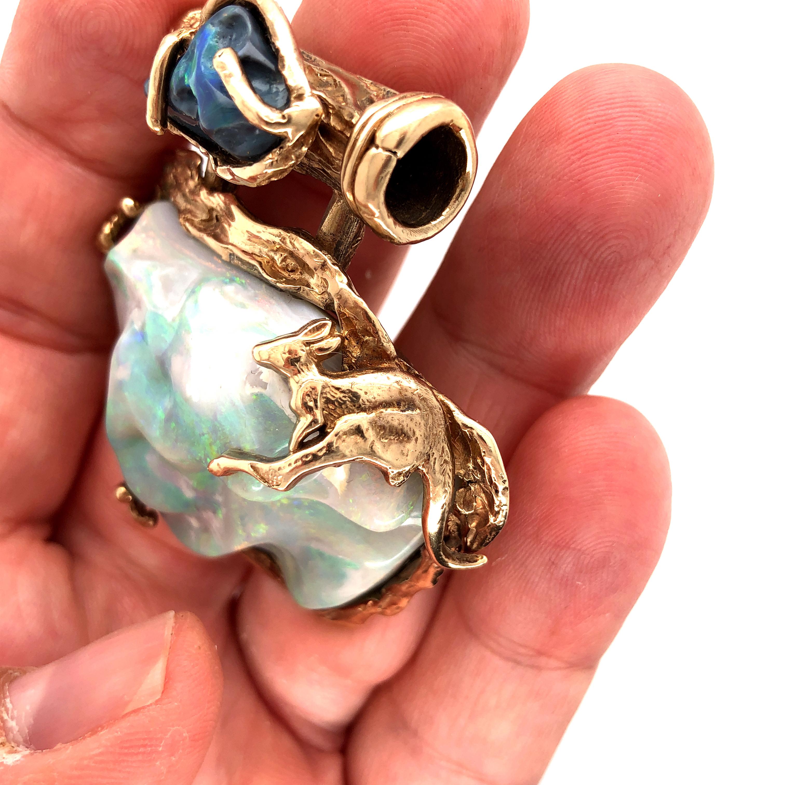 Offered here is a unique size and shape Australian Opal set in 14kt gold pendant. This pendant is truly one of a kind. The pendant has a large off shape natural Opal set with prong setting with a kangaroo on the top right, plus you have an off shape