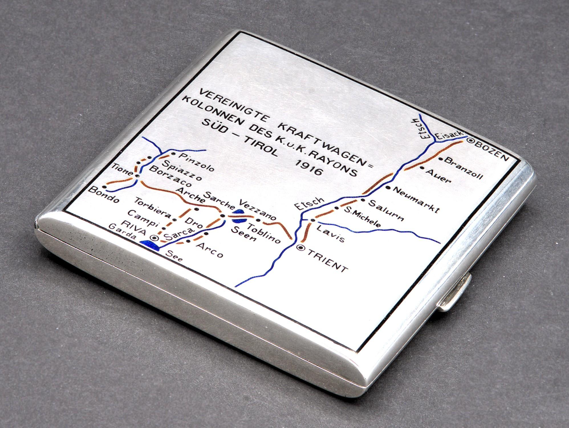 This is without question a most unique Austrian silver cigarette case, the front of the case is decorated with a finely detailed road map in coloured enamels, against a white enamelled surface, commemorating 'The United Motor Car Columns of the