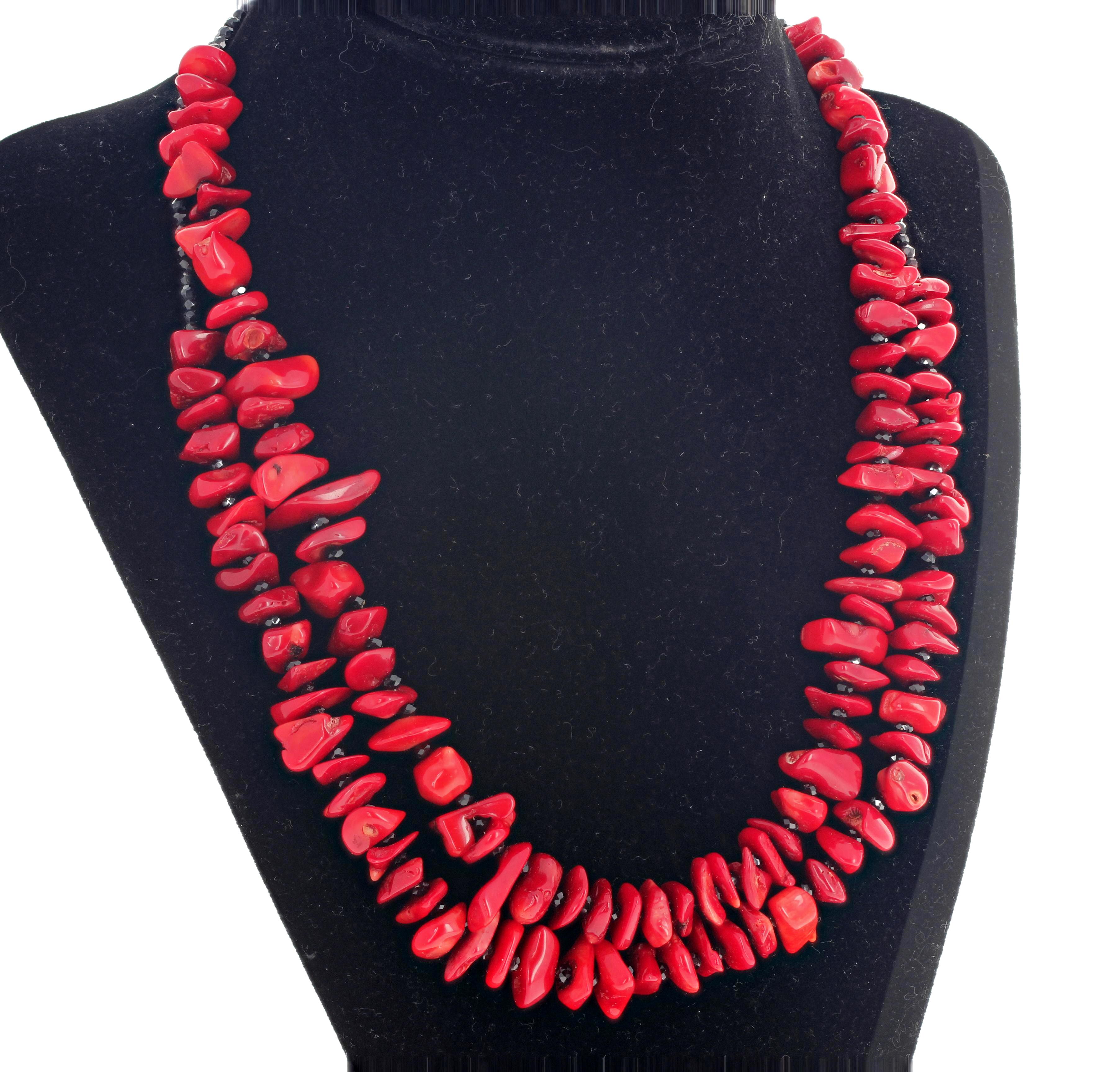 Double strand of beautiful highly polished chips and chunks of red real Bamboo Coral set with sparkling real gem cut black Spinel set with a sterling silver hook clasp in a 17 3/4 inch long necklace.