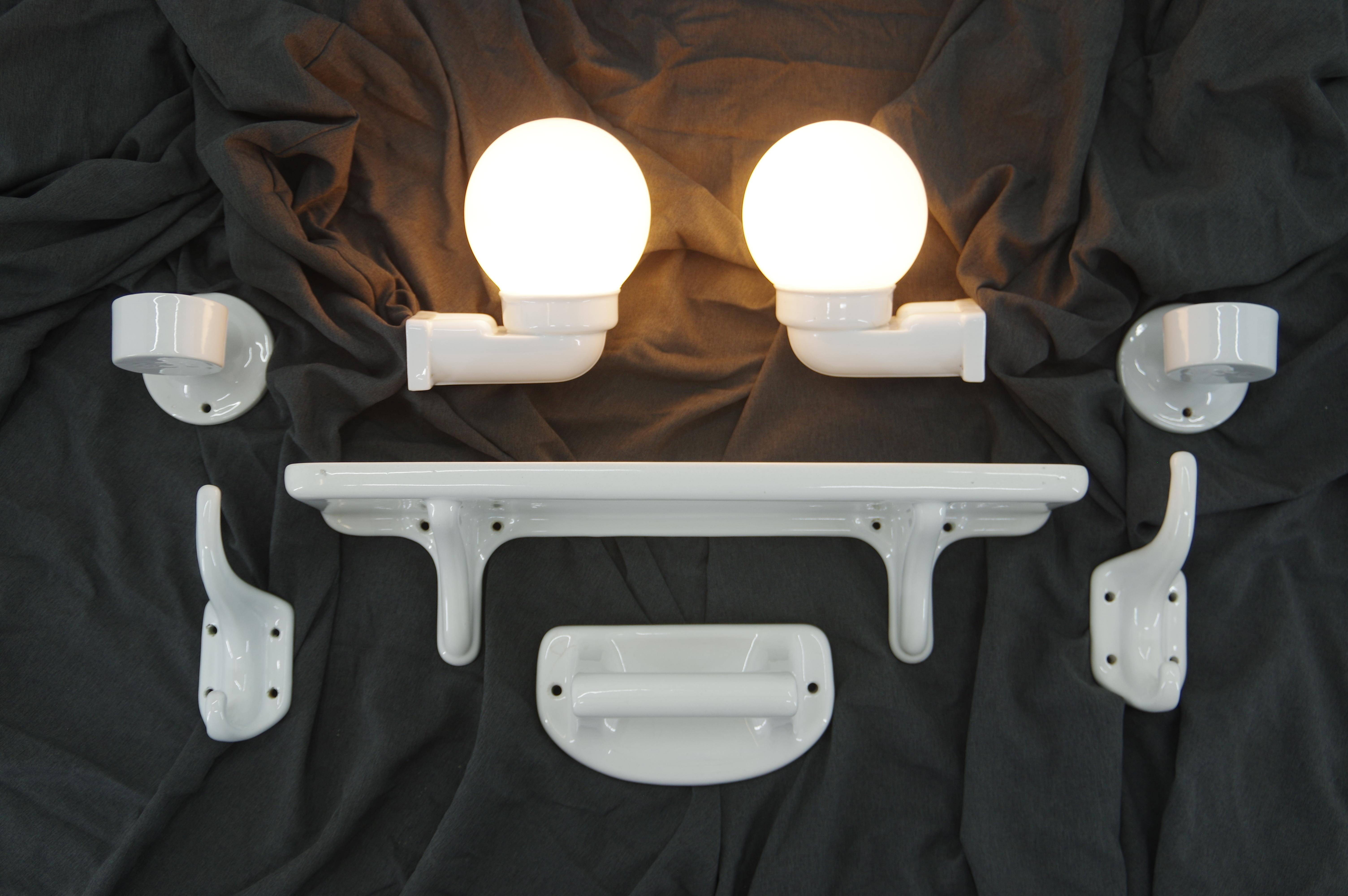 Set of Art Deco or Bauhaus bathroom accesories by Ditmar Urbach from late 1920s. Two wall lamps (E27 or E26 socket), one shelf, two hooks, two toothbrush holders and one bath wall holder. Very good condition, only one crack on toothbrush holder was