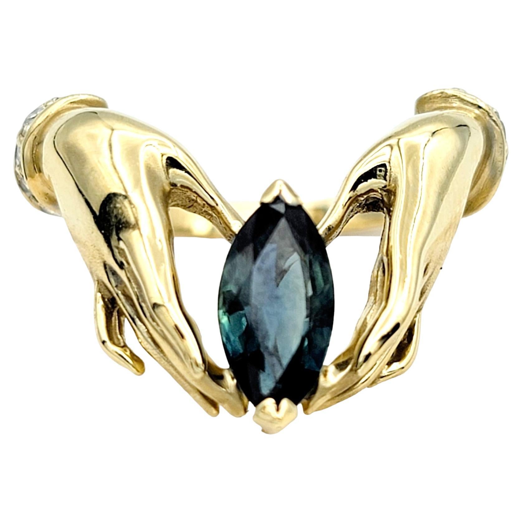 Ring size: 7.25

Capture the essence of eternal connection with our 14 karat yellow gold graceful hands ring, a timeless symbol of unity and beauty. The unique sapphire and diamond design makes a lovely statement piece that will not go unnoticed.