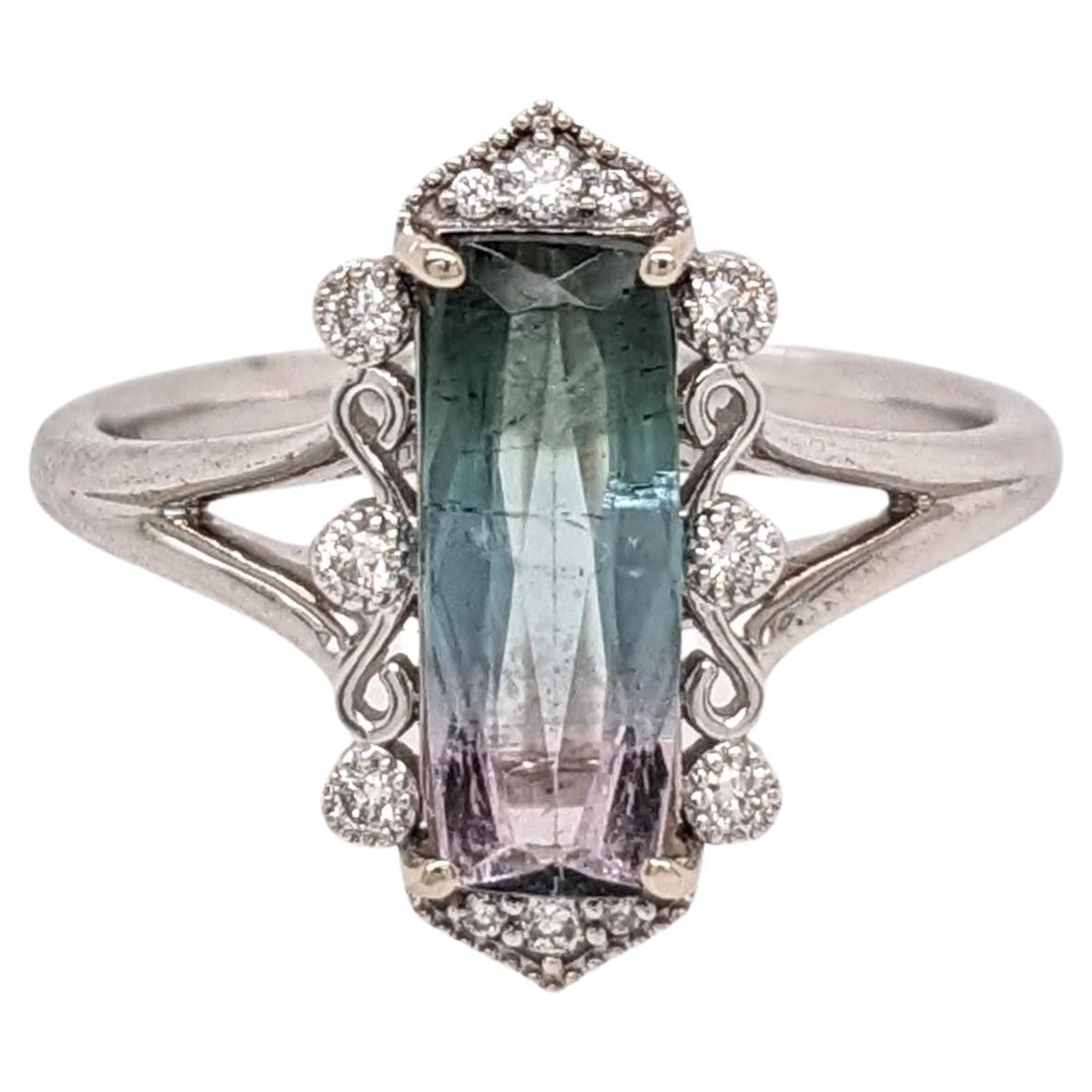 This statement ring features an absolutely gorgeous teal to pink bi-color tourmaline!! What a unique and stunning natural gemstone color combination! Made in 14k white gold with natural earth mined diamond accents and milgrain detail giving a