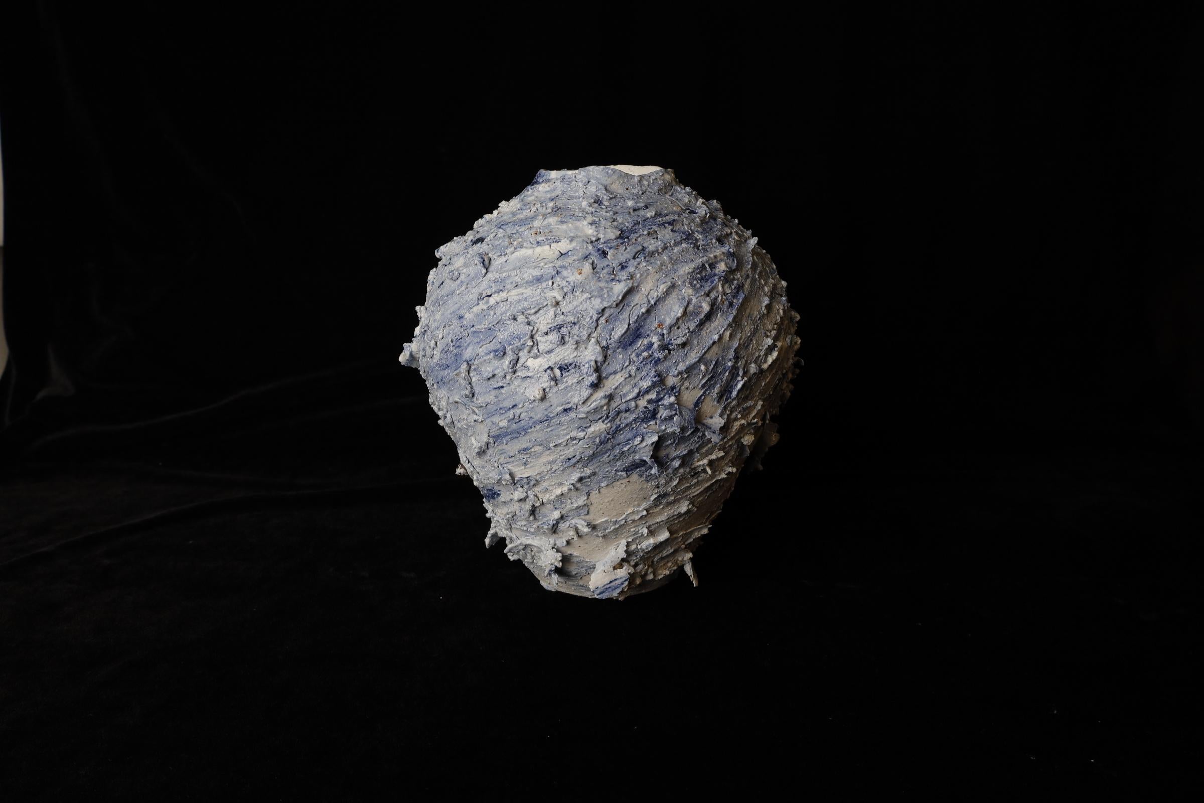 This exceptional wild porcelain vase by renowned Bizen pottery artist Kazuya Ishida is a true masterpiece. Crafted from unrefined clay mined in Bizen, Kobe Prefecture, Japan, this vase is a one-of-a-kind piece that celebrates the raw beauty of its