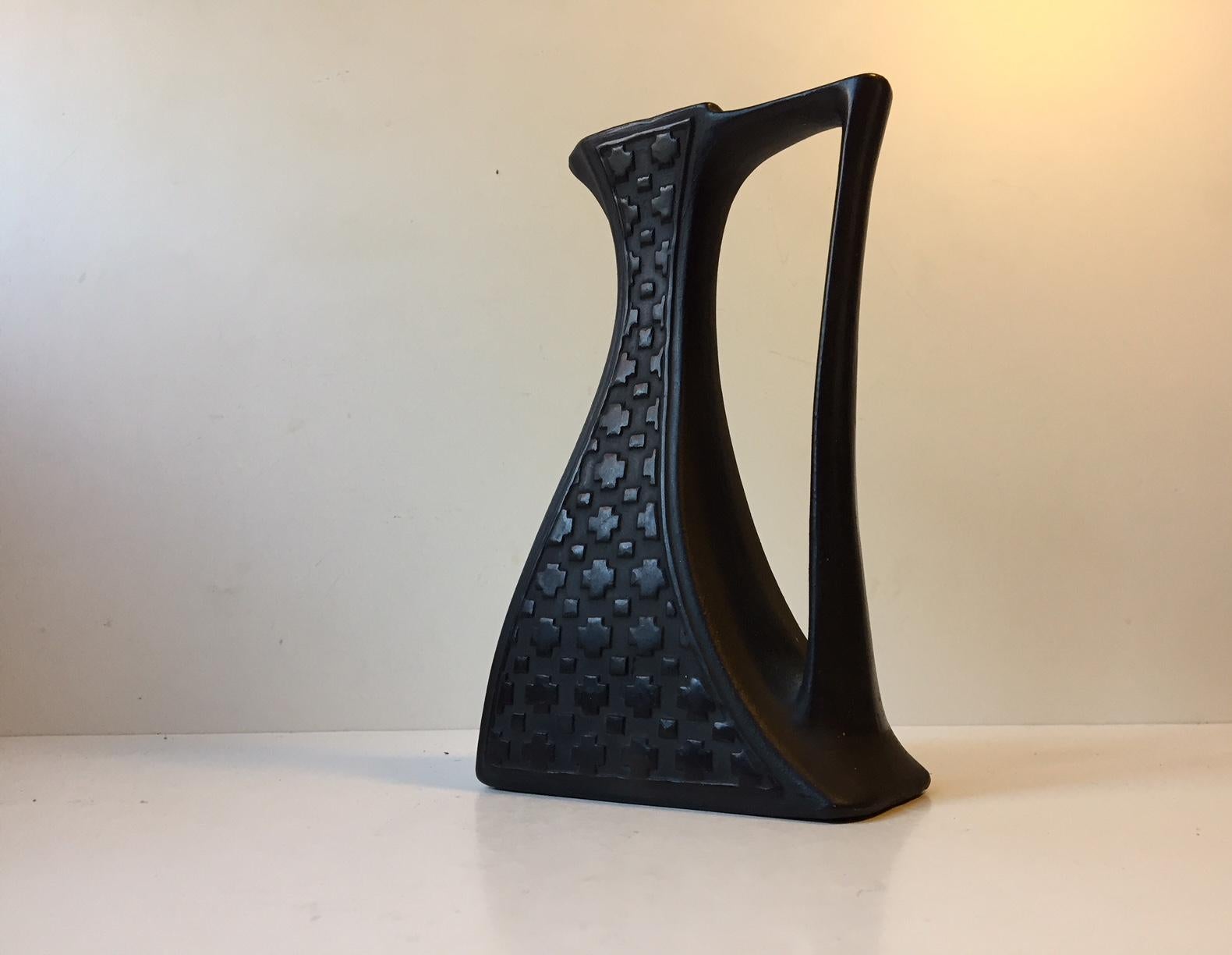 This is a unique black terracotta jug or vase by Sejer Denmark. The style of this piece is Art Deco and the geometric shapes to both sides and the tilting shape is a testimony of this ideal. It is stamped Sejer, 1400 to the base.