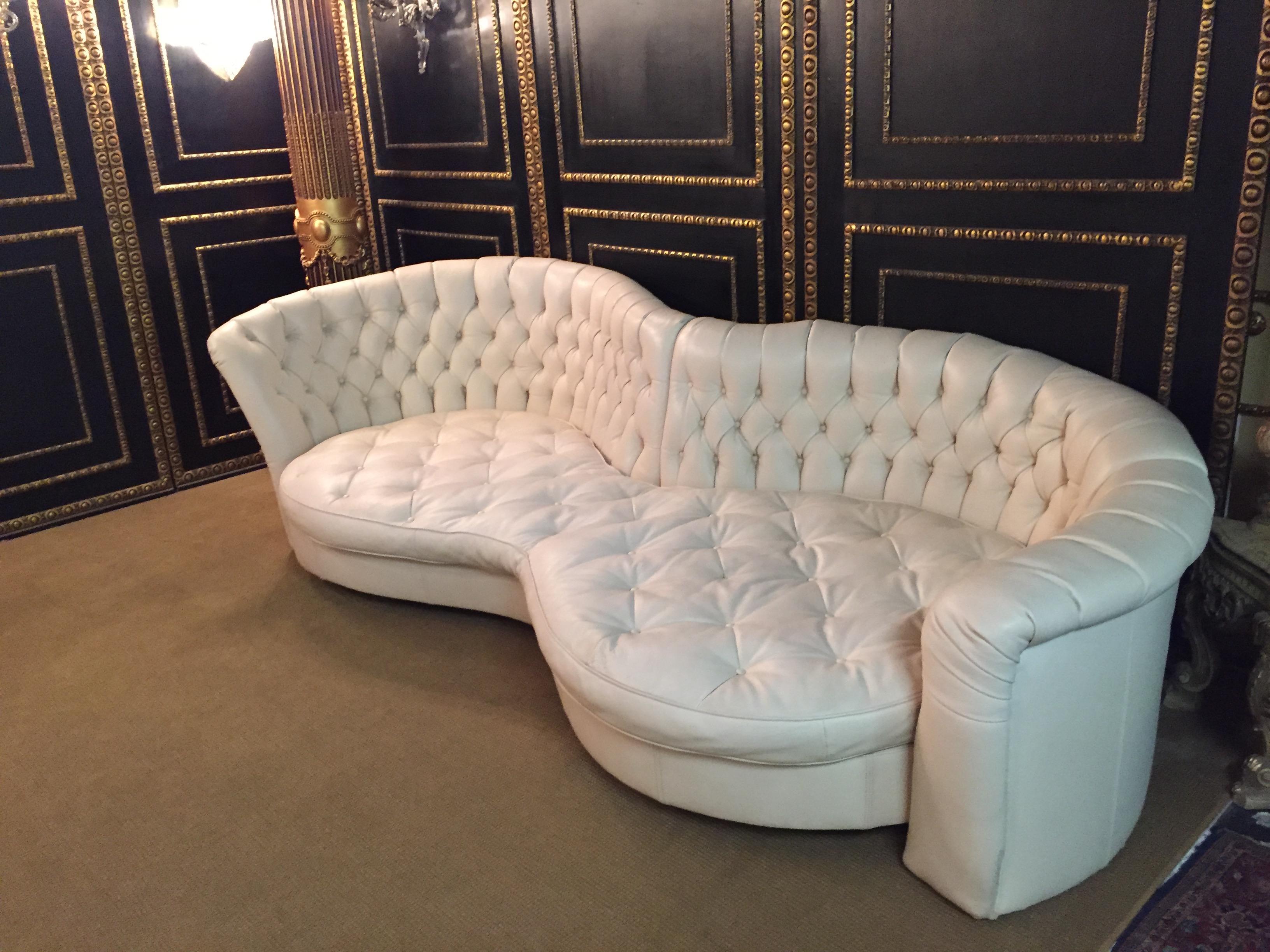 Large designer sofa by the famous  company Bretz made in Germany
Genuine leather with button stitching
Chesterfield style.
With matching table with glass top.