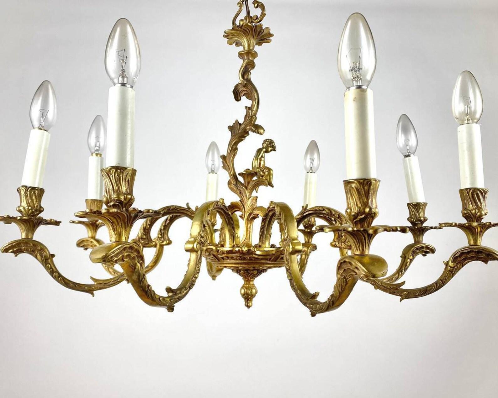 
The material of manufacture of this unique chandelier is a real 100% gilded BRONZE, which is valued all over the world and is characterized by increased strength, corrosion resistance and durability. 

Pay attention to the cute figure of a sitting