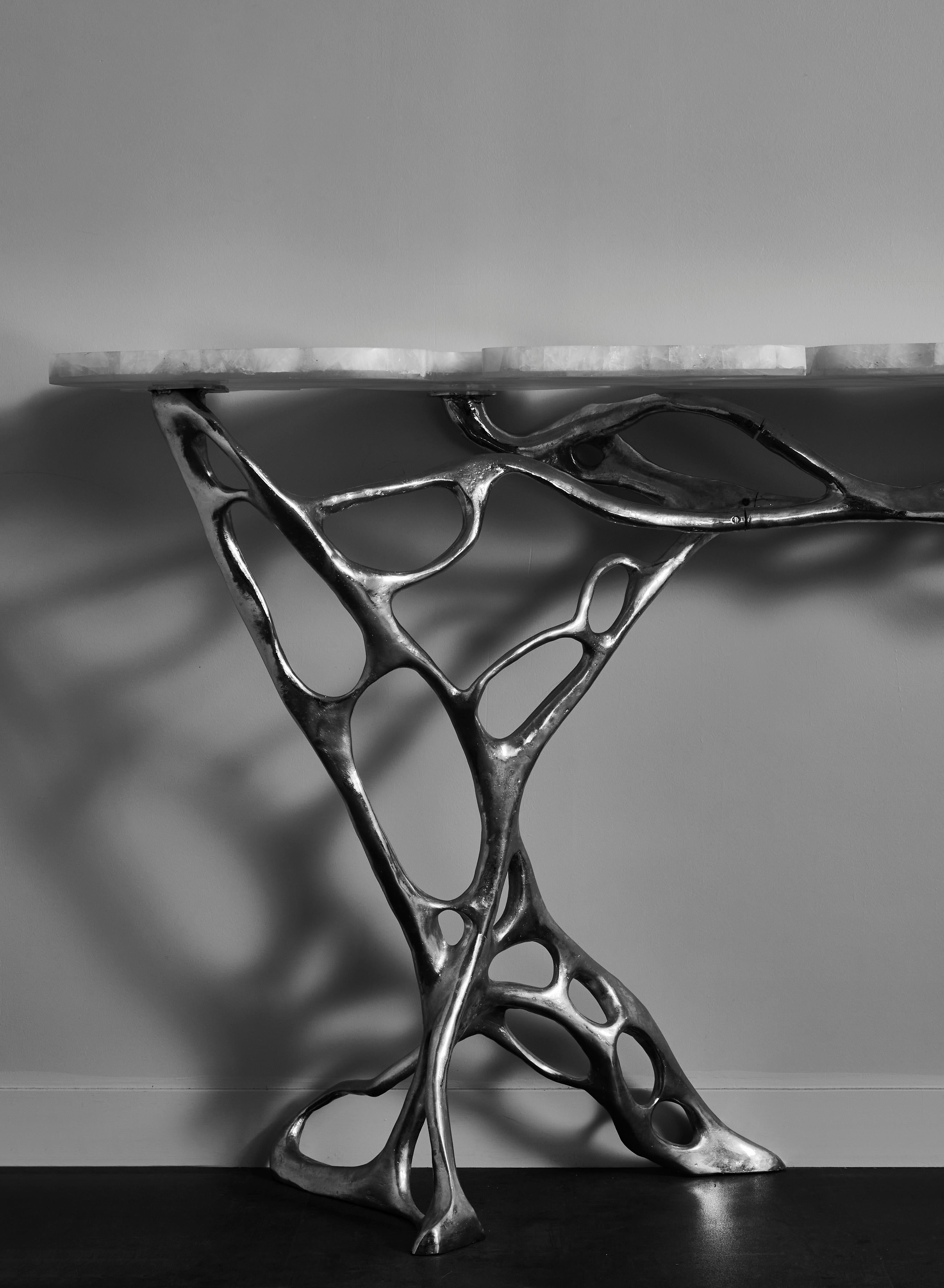 Exceptional console in sculpted and nickeled massive bronze with a sculpted rock crystal top. 
Unique piece by Studio Glustin.
France, 2017.