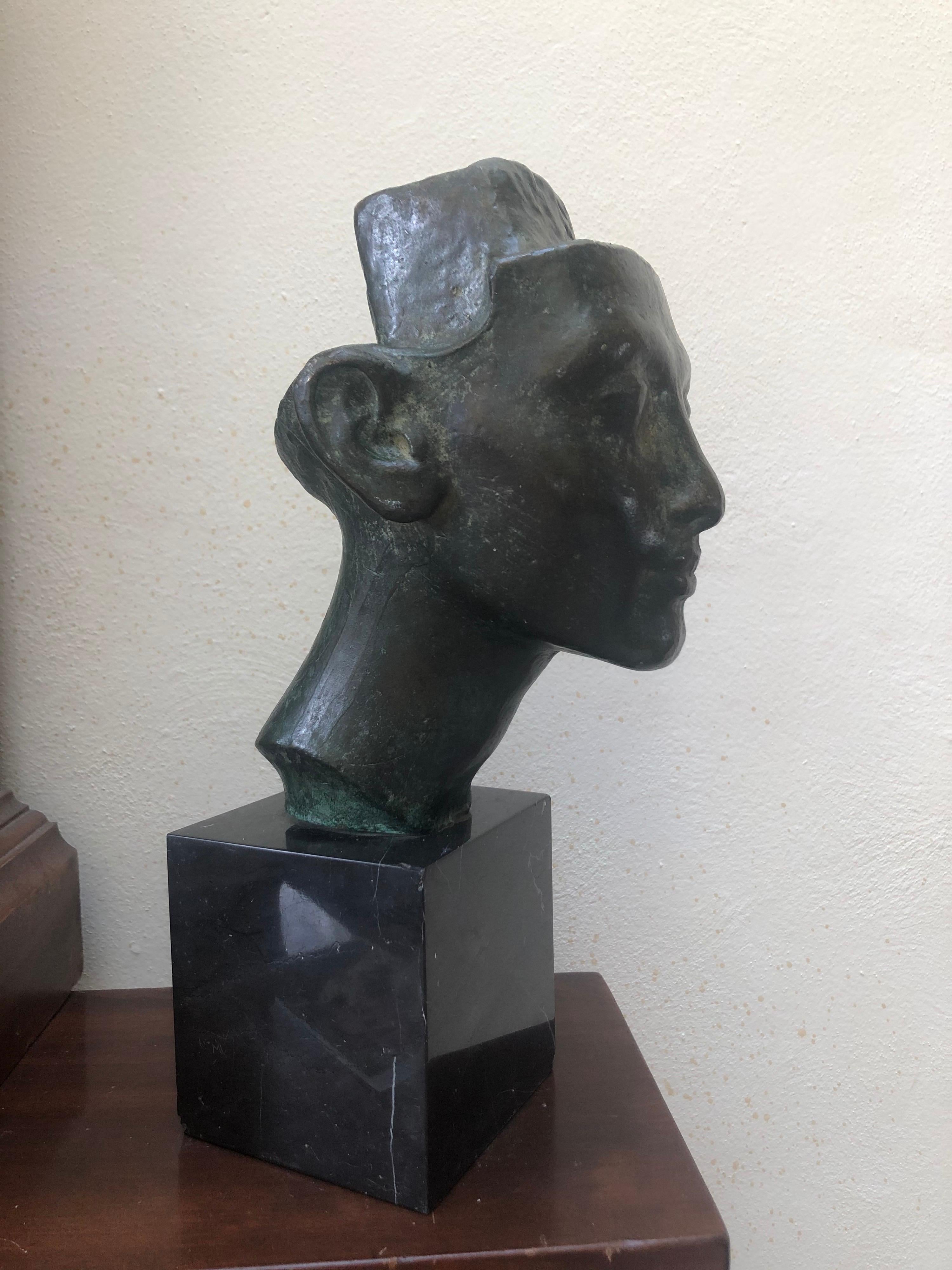 Fine detail, lovely factions and subtle smile on this rare bronze head sculpture 
Fix to a black marble base.
 