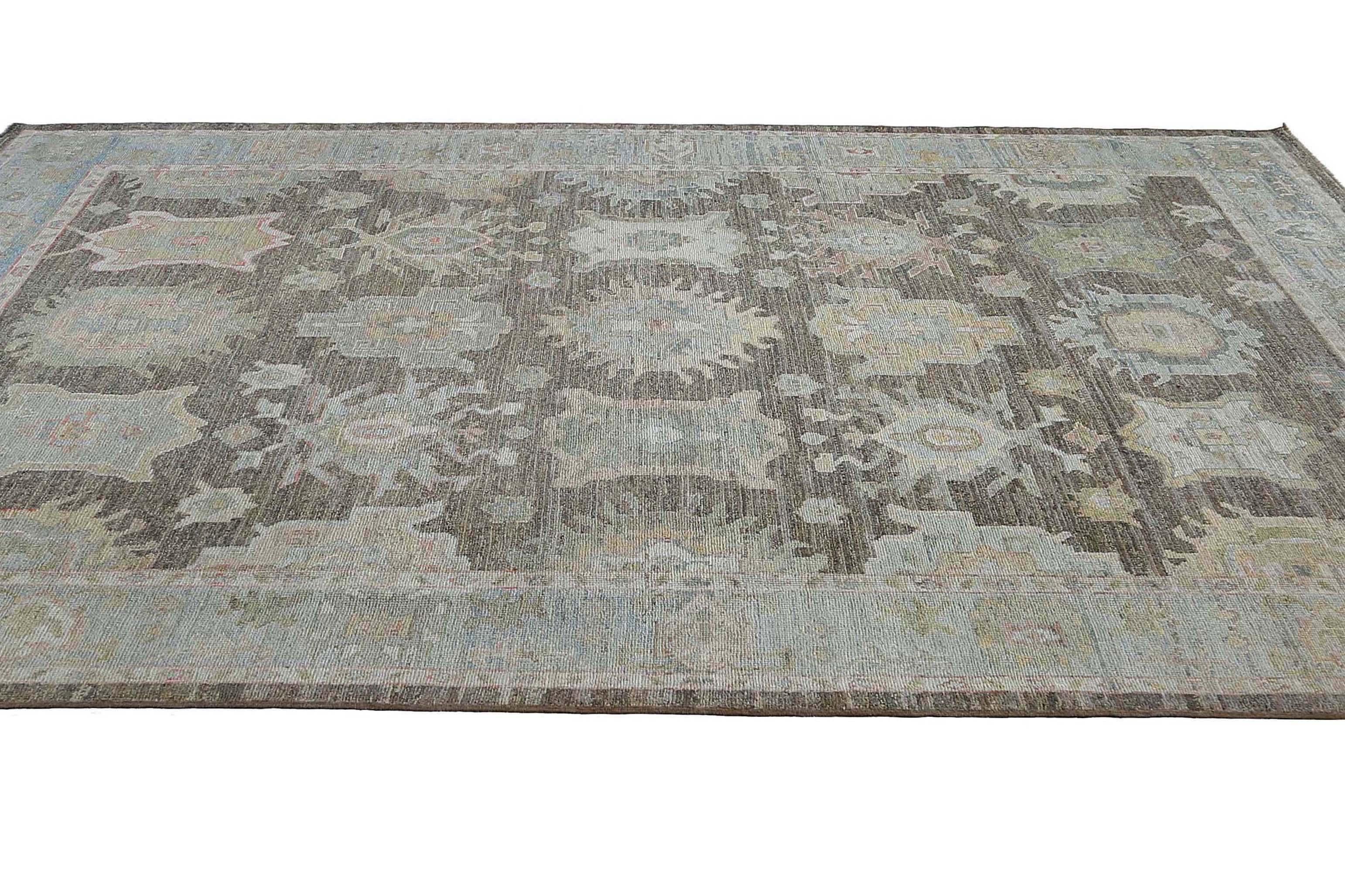 Elevate the ambiance of your living space with our stunning 10.0'' x 13.2'' handwoven Oushak rug. With a brown foundation and captivating blue colors, this rug is perfect for adding a pop of color and sophistication to any room.

Crafted from